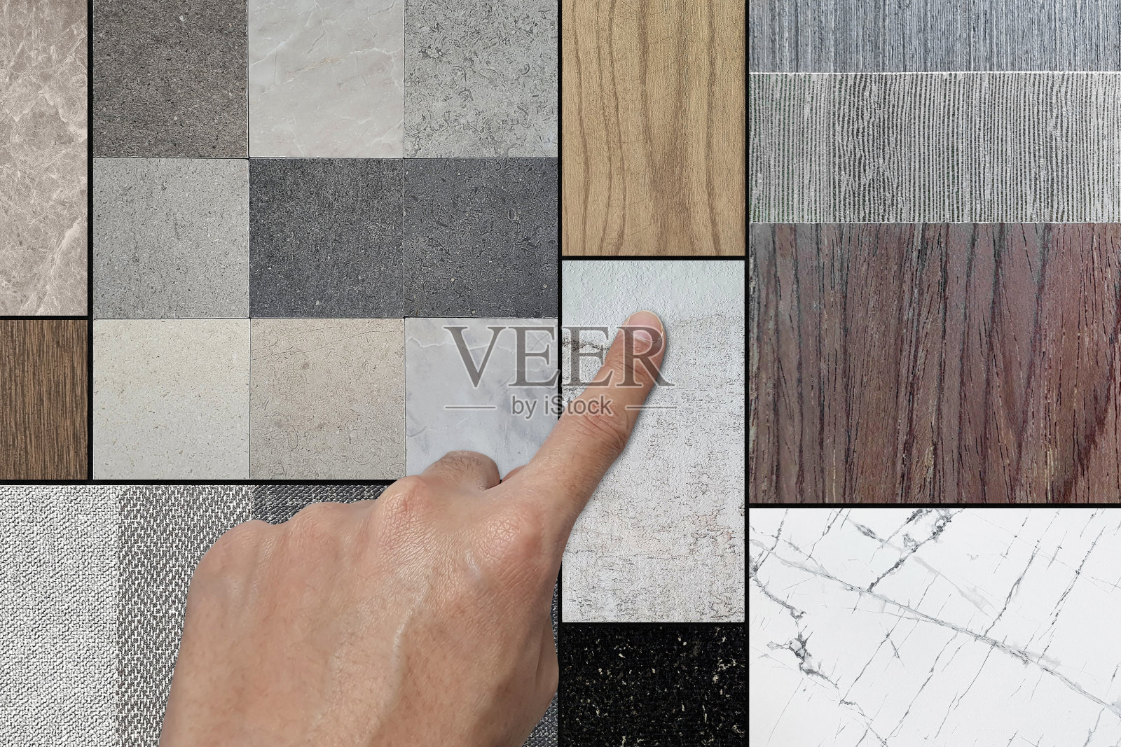 室内设计师在情绪板上选择材料样品，包括木饰面、石材瓷砖、层压织物、白色卡拉拉大理石、黑色水磨石、木纹塑胶地板的特写镜头。照片摄影图片