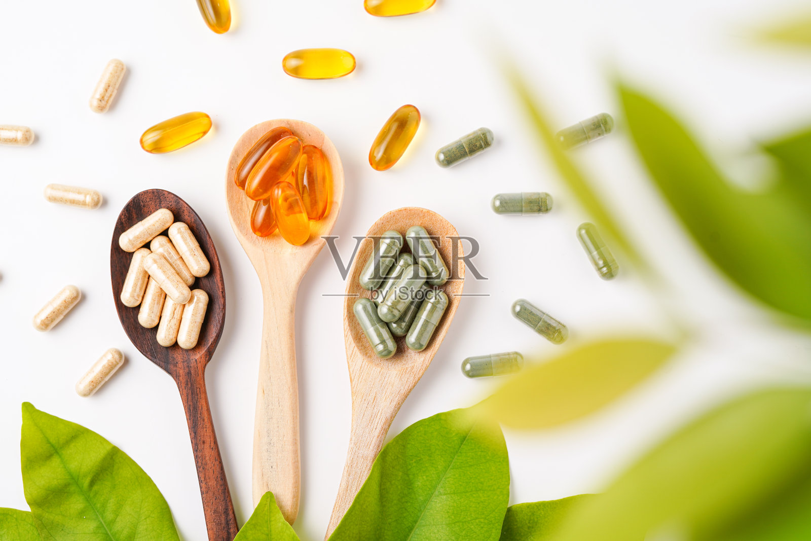 木勺维生素胶囊，软凝胶，鱼油胶囊，欧米伽3，欧米伽9，维生素D，维生素E照片摄影图片