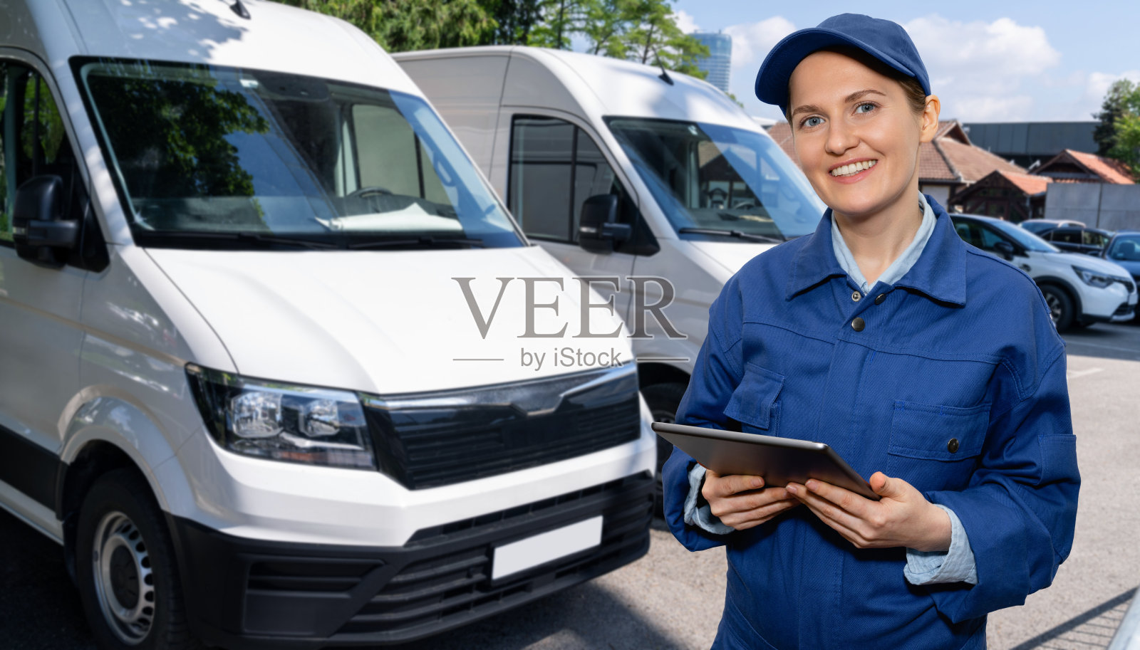 经理在货车旁边拿着一个数字平板电脑。照片摄影图片