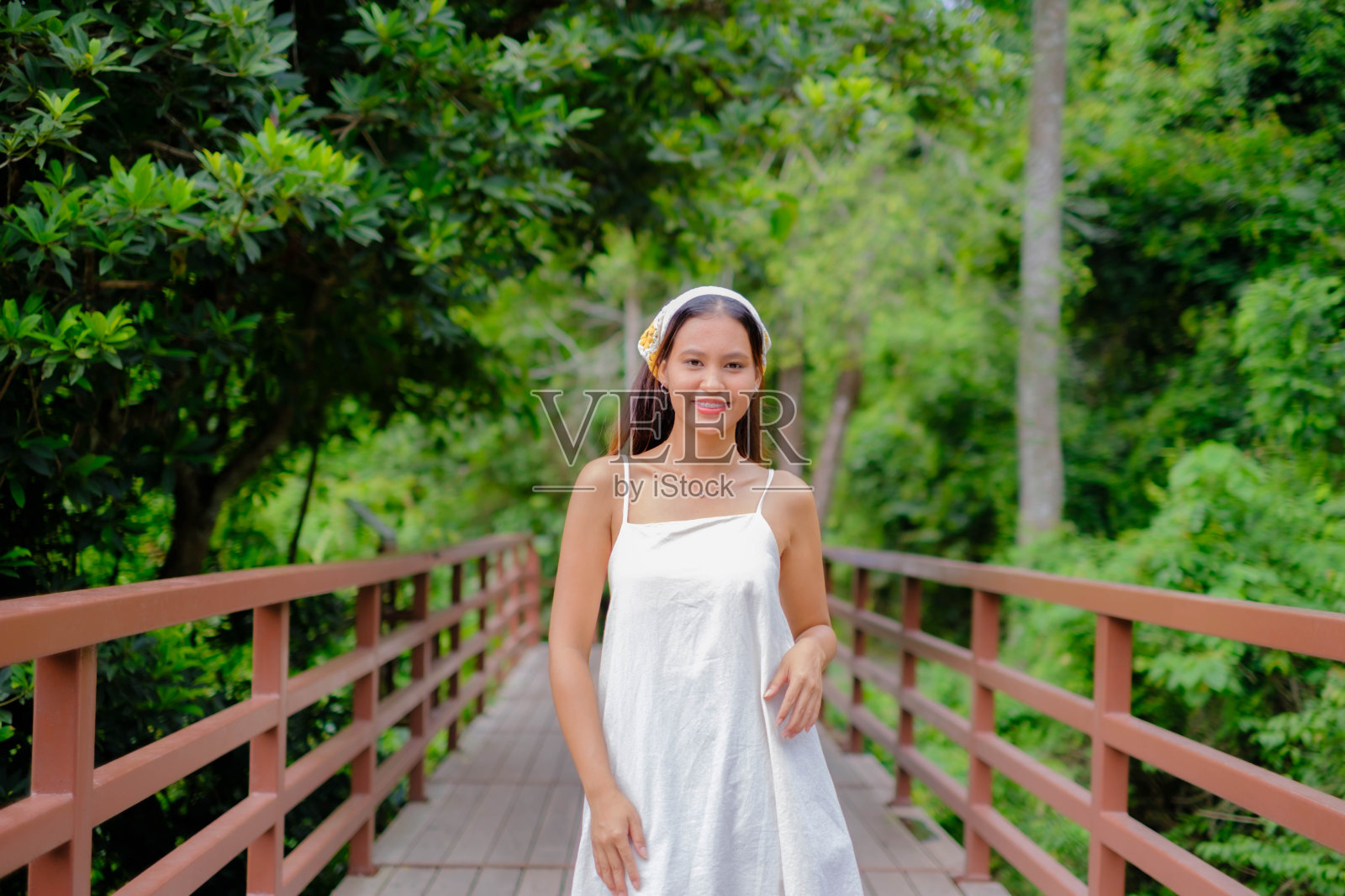 年轻的亚洲女子在桥上玩蝴蝶照片摄影图片