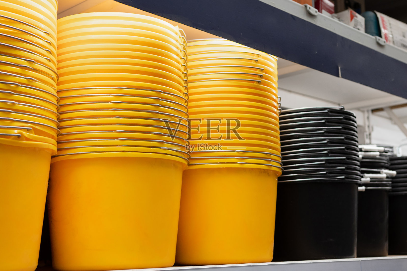 超市柜台上五颜六色的塑料盆和塑料桶照片摄影图片