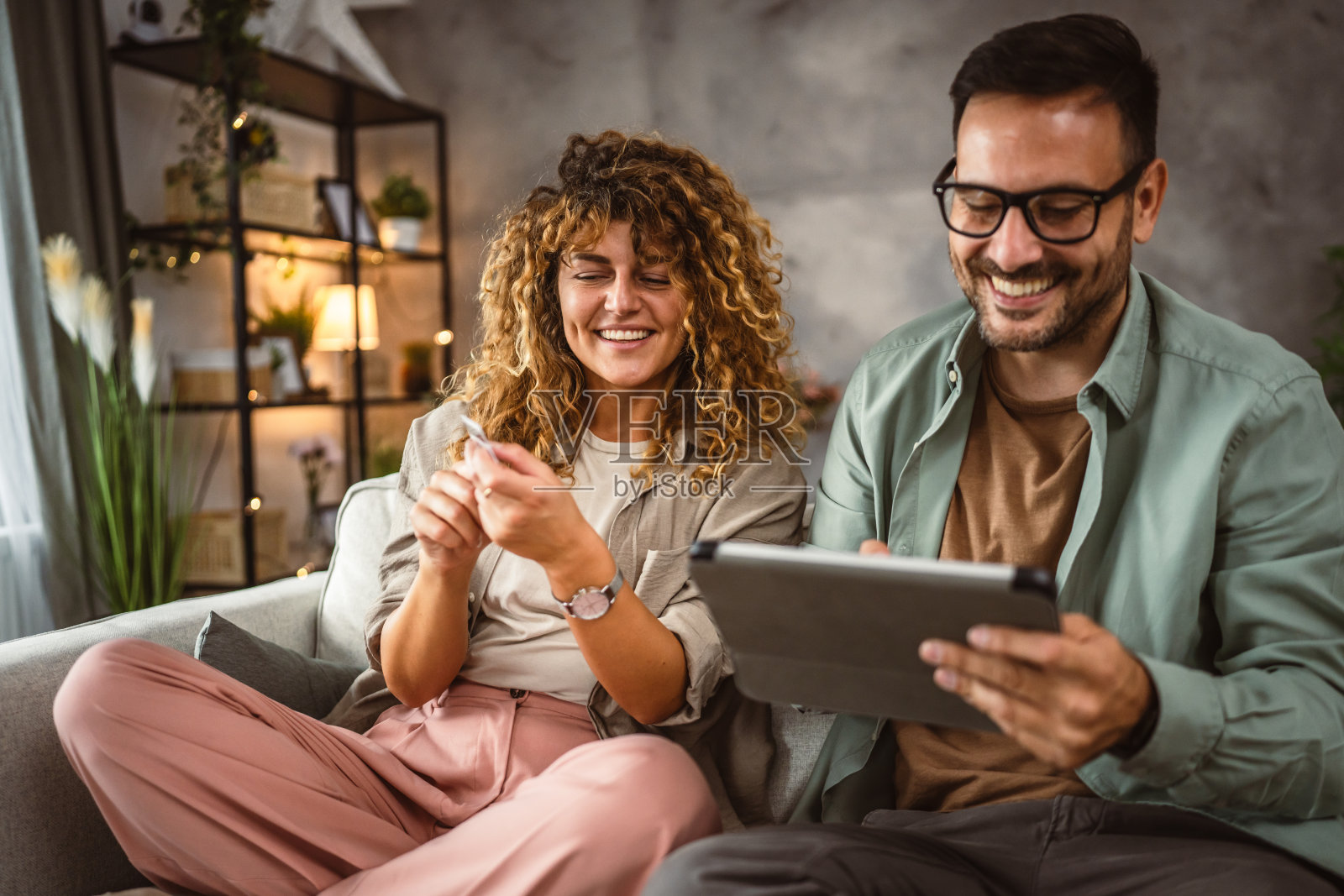 男女朋友在家用信用卡在平板电脑上网购照片摄影图片