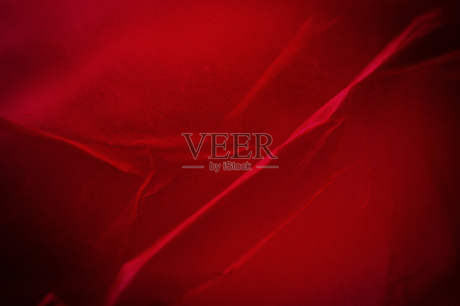 红色空塑料袋背景的极端特写。照片摄影图片