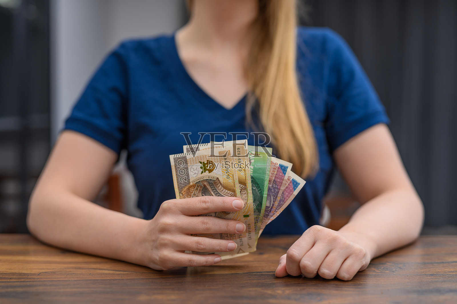 年轻自信的女孩手里拿着现金和积蓄照片摄影图片