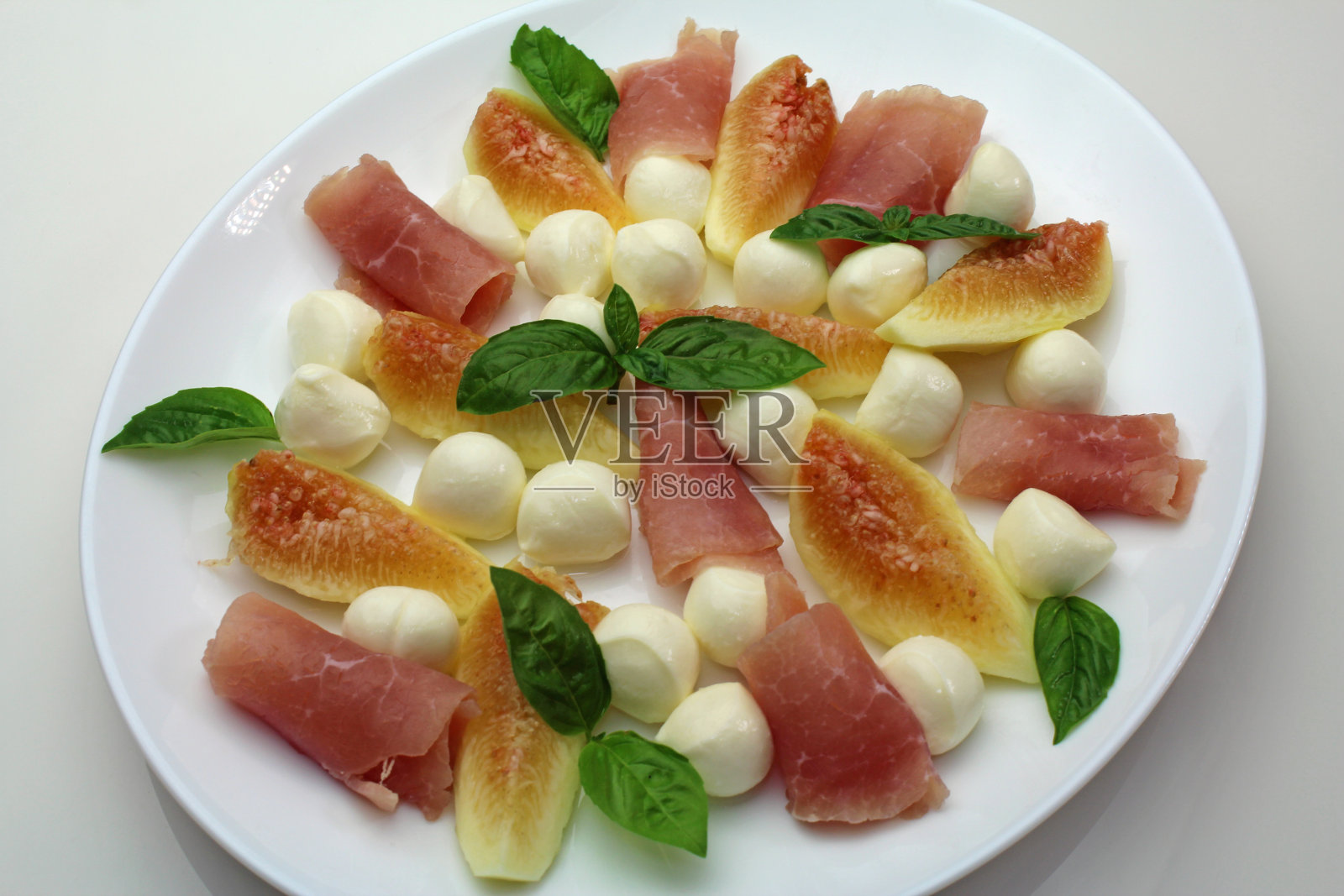无花果，马苏里拉奶酪和熏火腿开胃菜照片摄影图片