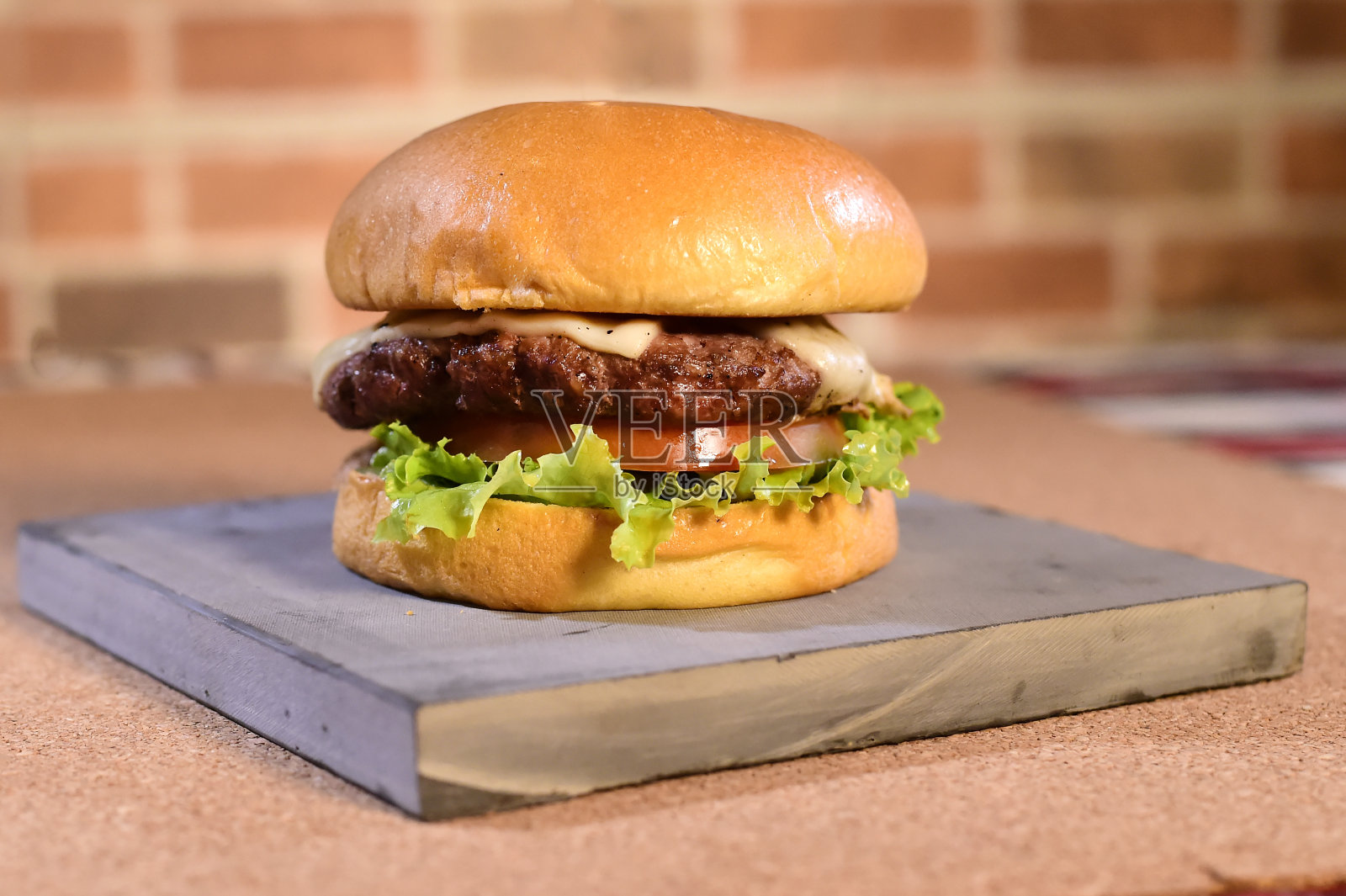 牛肉汉堡，三明治，面包，沙拉，洋葱和奶酪快餐，孤立在木桌上照片摄影图片