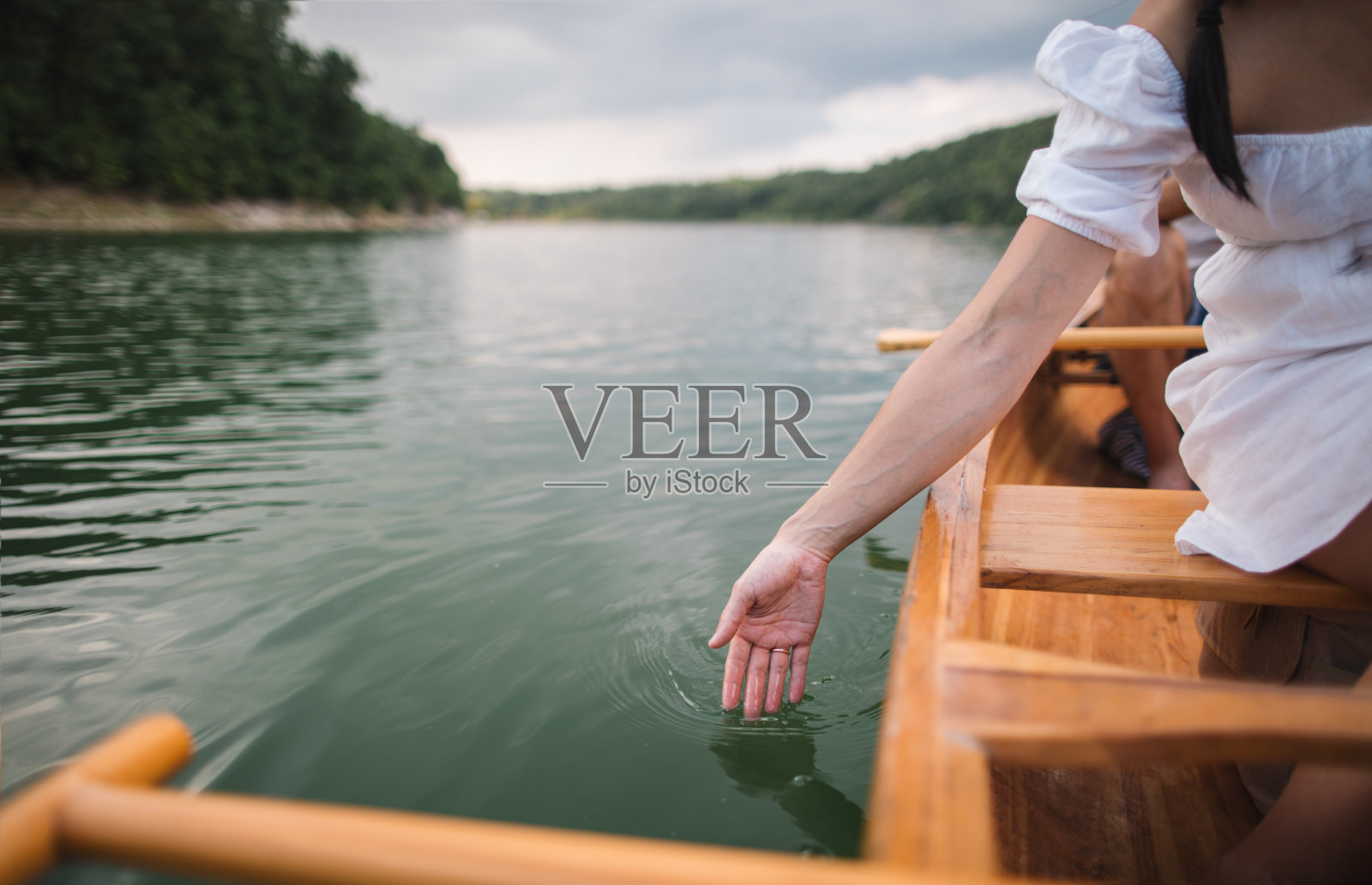 女性的手触摸水面的特写照片摄影图片