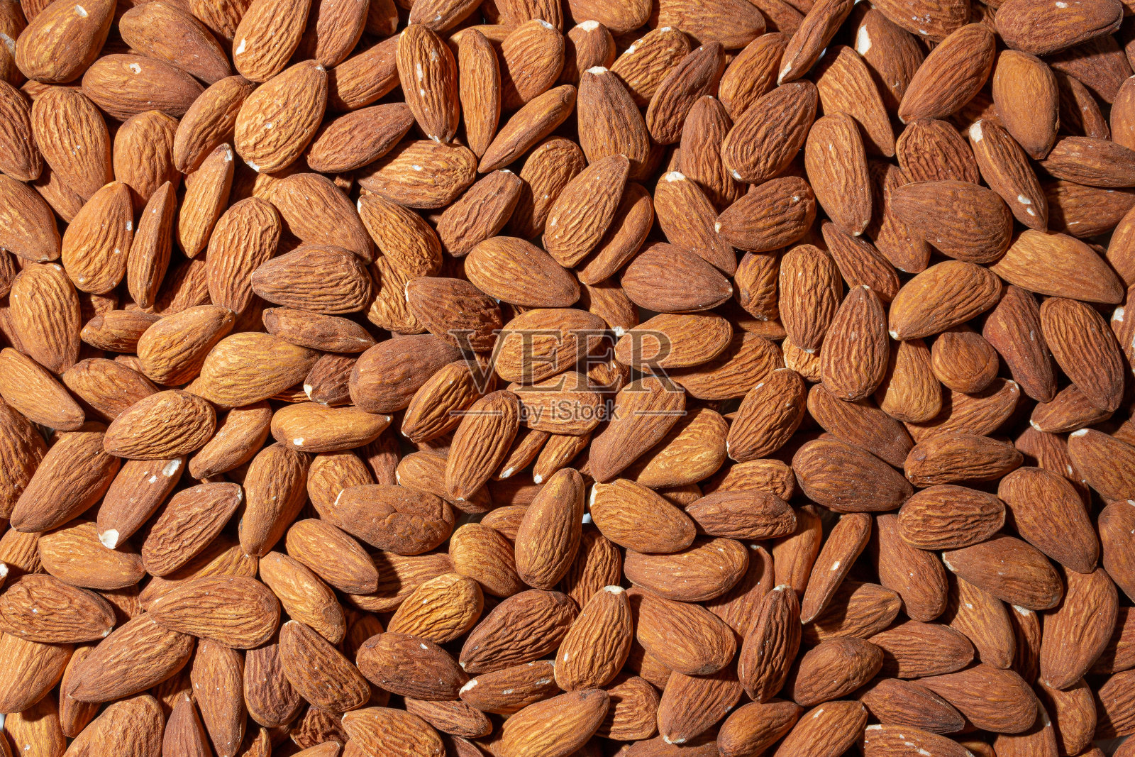 分散的杏仁。杏仁坚果的背景照片摄影图片