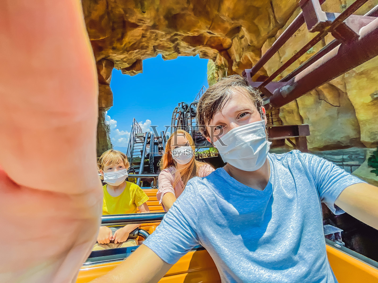 在2019冠状病毒病期间，一家人在游乐园戴着医用口罩照片摄影图片