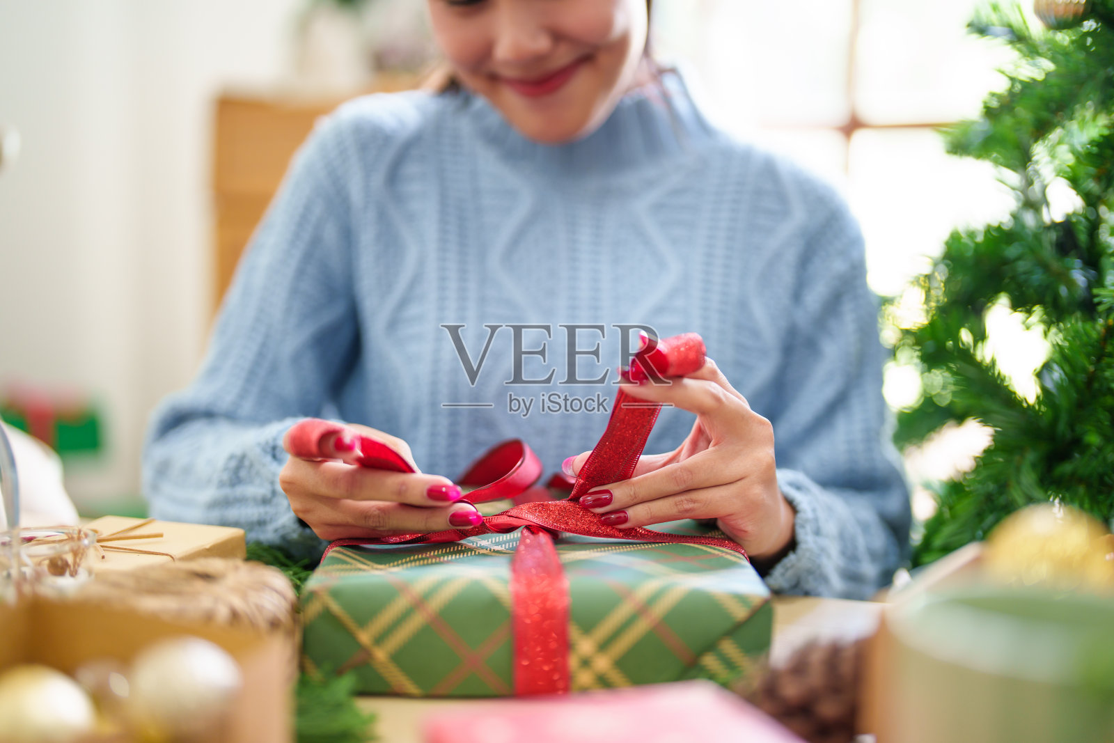 女人在针织毛衣包装圣诞节presentsÂ与生态纸女孩包装圣诞礼物圣诞节假期的概念照片摄影图片