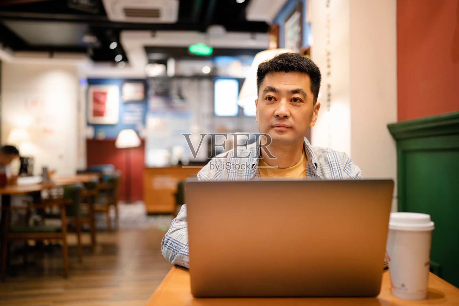 咖啡店里的亚洲中年男子照片摄影图片