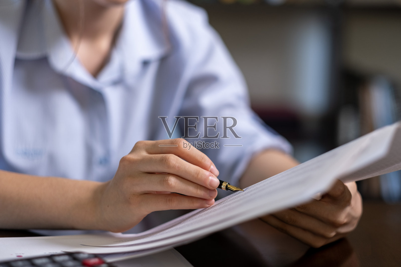 不知名的女人在检查纸上的数据照片摄影图片