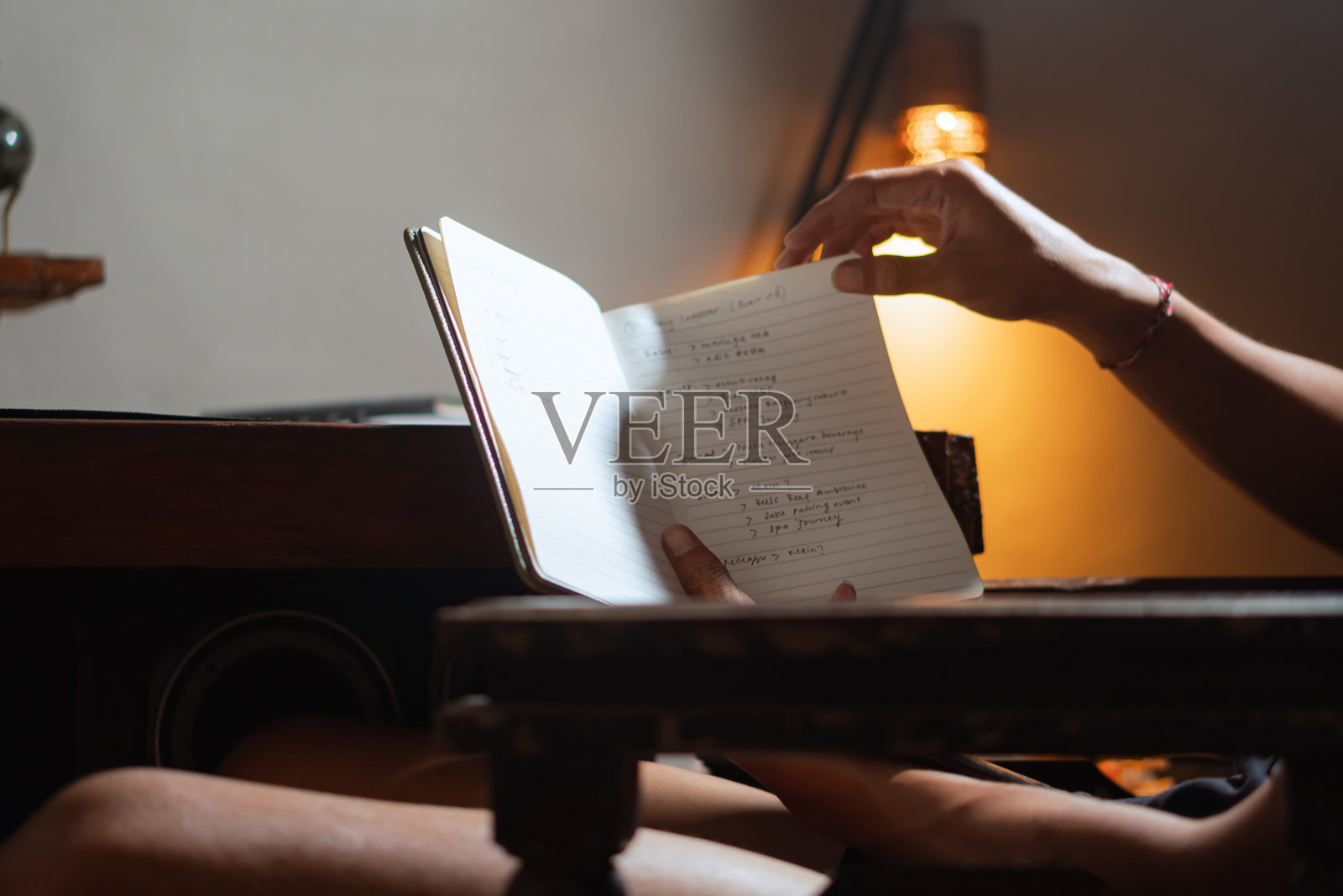 在笔记本上读手写笔记的人照片摄影图片