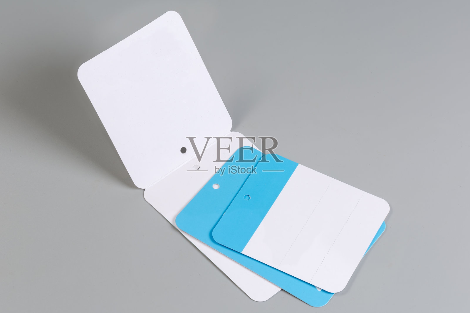 空白的蓝色和白色纸板衣服吊牌在绳子上照片摄影图片