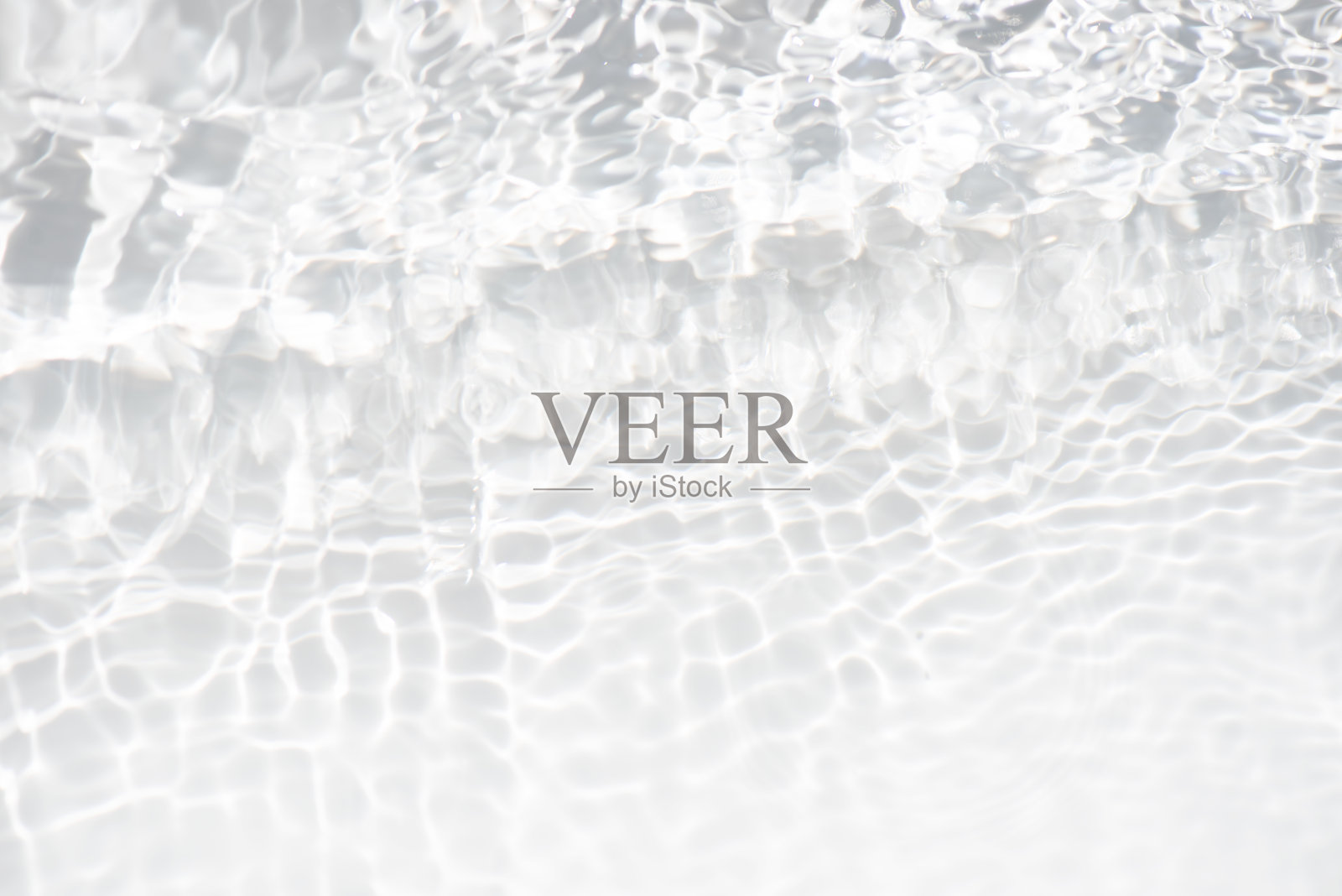 水面泛起涟漪的白水。散焦模糊透明白色彩色清澈平静水面纹理飞溅和气泡。水波与闪亮的图案纹理背景。照片摄影图片