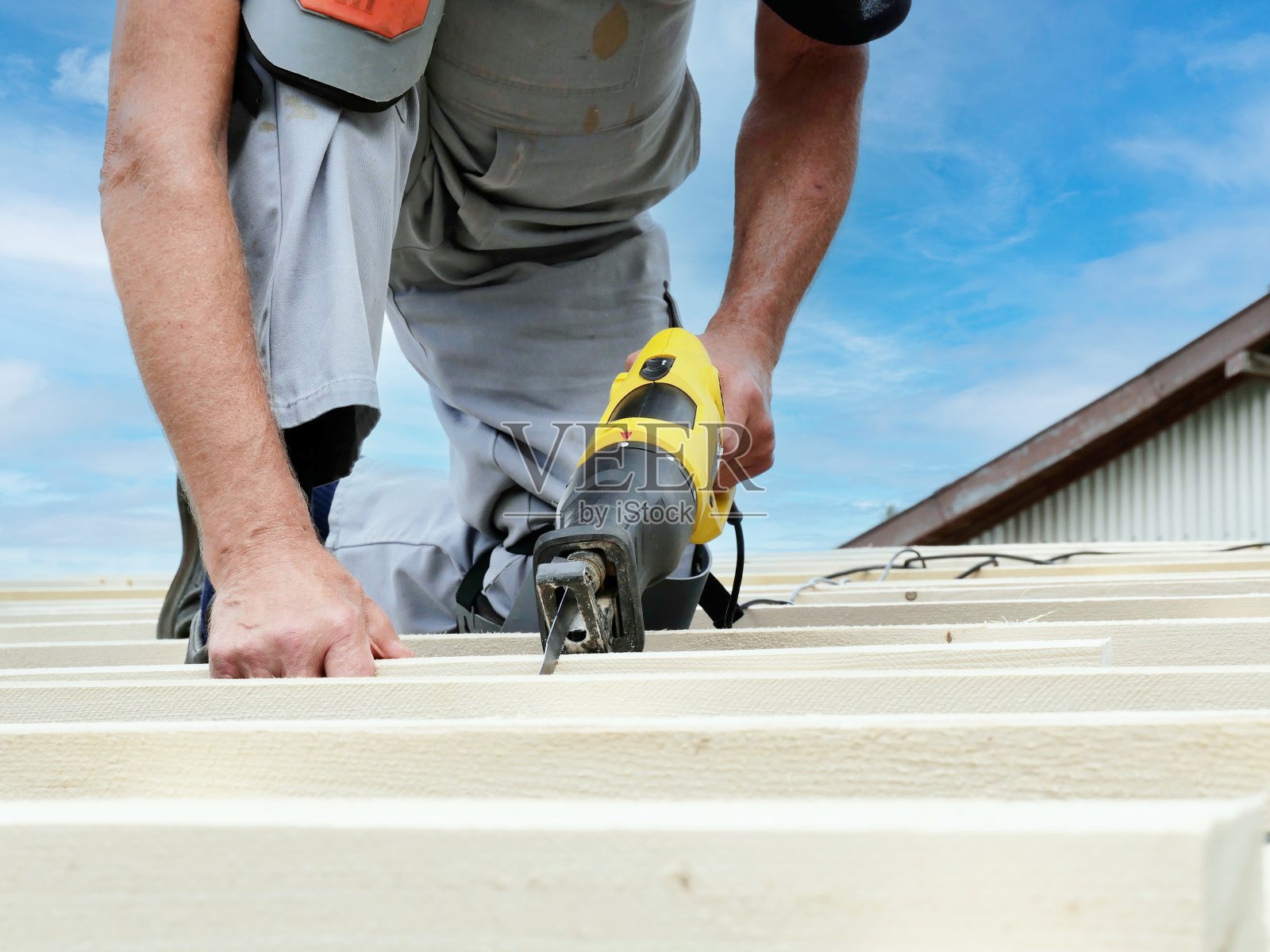 屋顶工人在屋顶上砍柴照片摄影图片