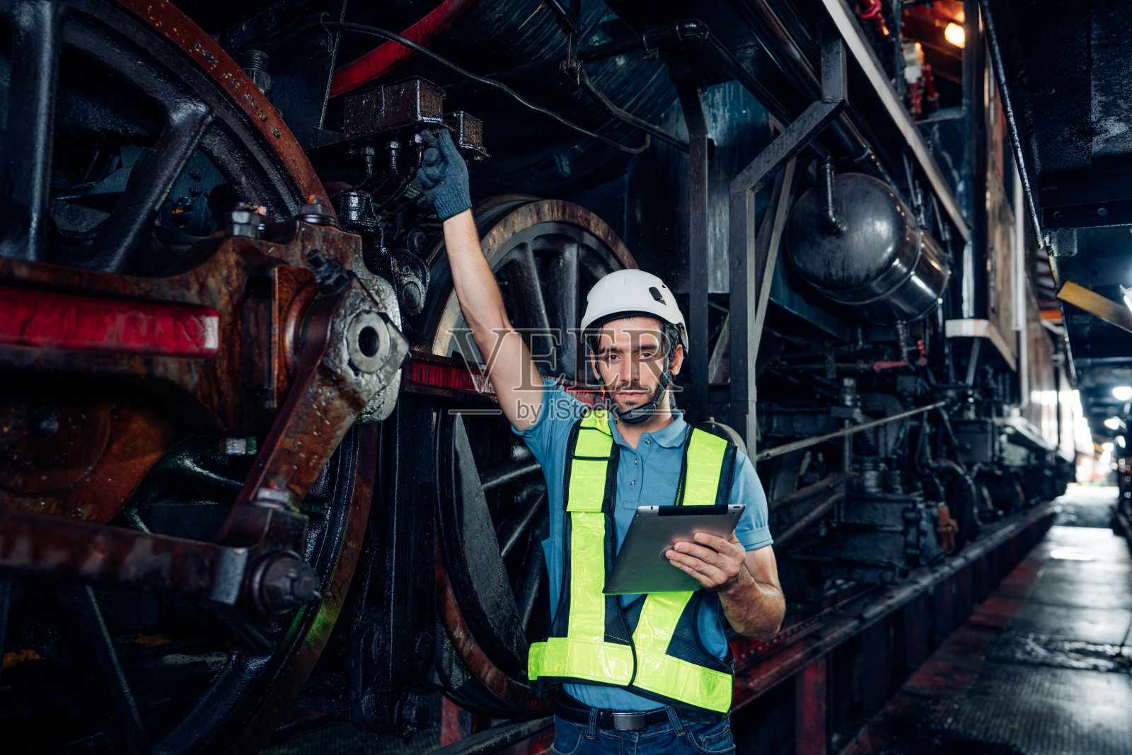 铁路工程师在列车检查下工作。照片摄影图片