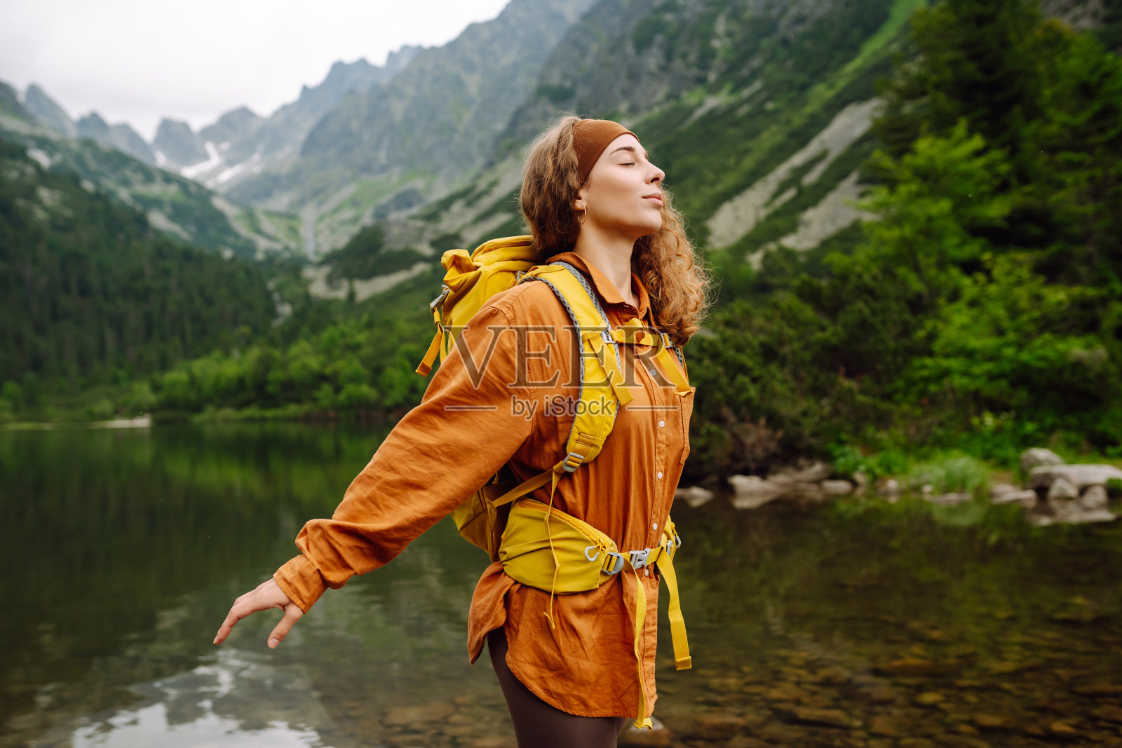 女旅行者背着背包徒步大自然。照片摄影图片