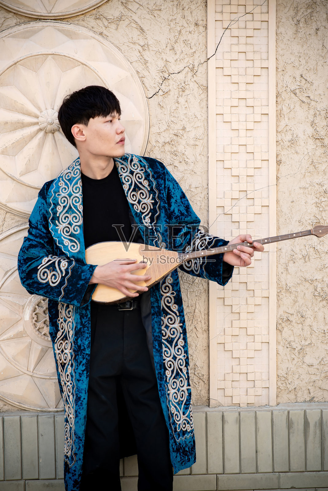 哈萨克男子身穿民族服装，头戴长袍和头巾照片摄影图片