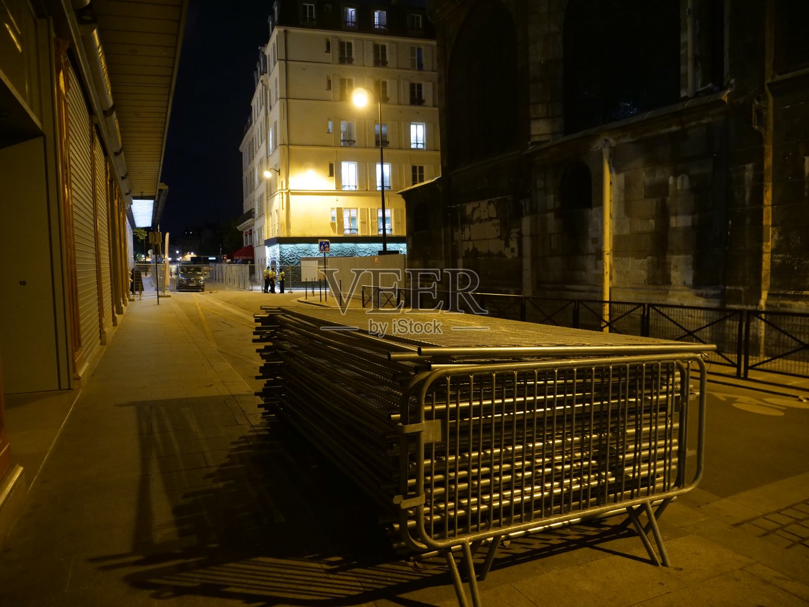 在法国首都巴黎的街道上,一些金属栅栏排成一排。照片摄影图片