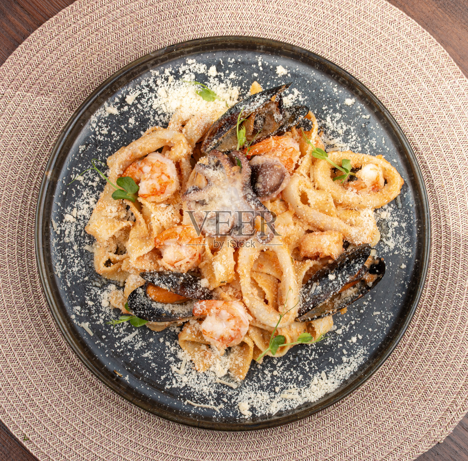 蕃茄奶油酱海鲜意面。这道意大利风味的菜提供了一个令人愉快的组合，质地和味道来自大海。照片摄影图片