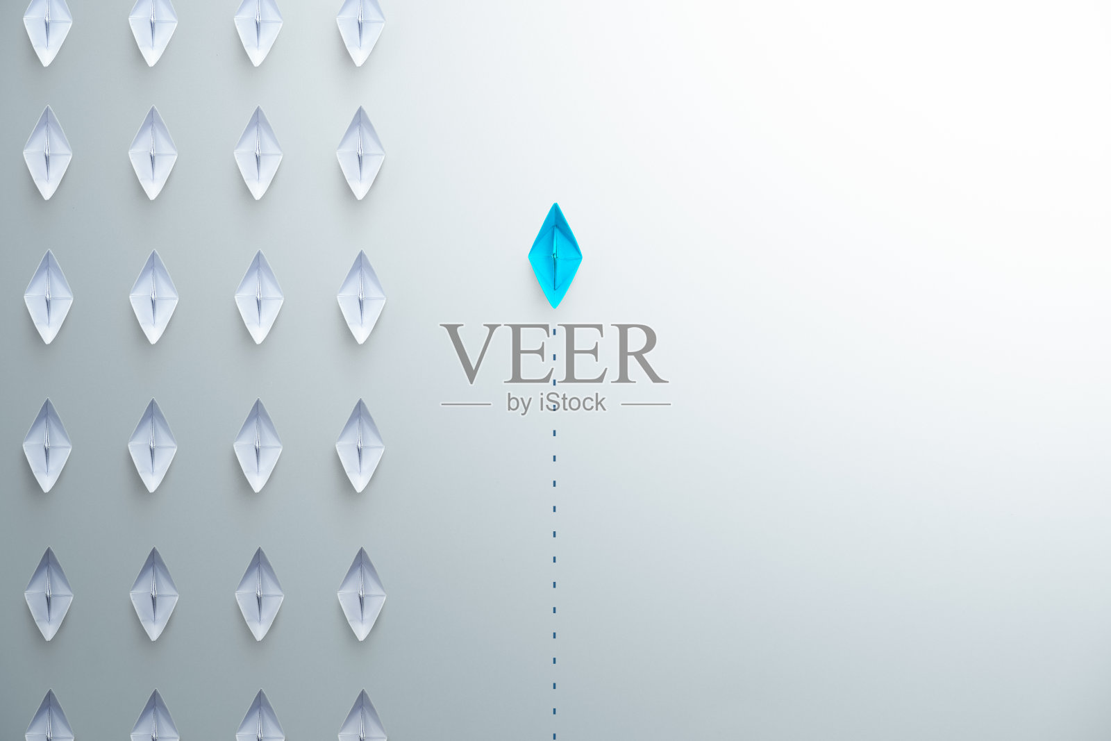 在白色背景上，一组白色纸船指向一个方向，一组蓝色纸船指向不同的方向。企业追求创新的解决方案理念，复制空间照片摄影图片