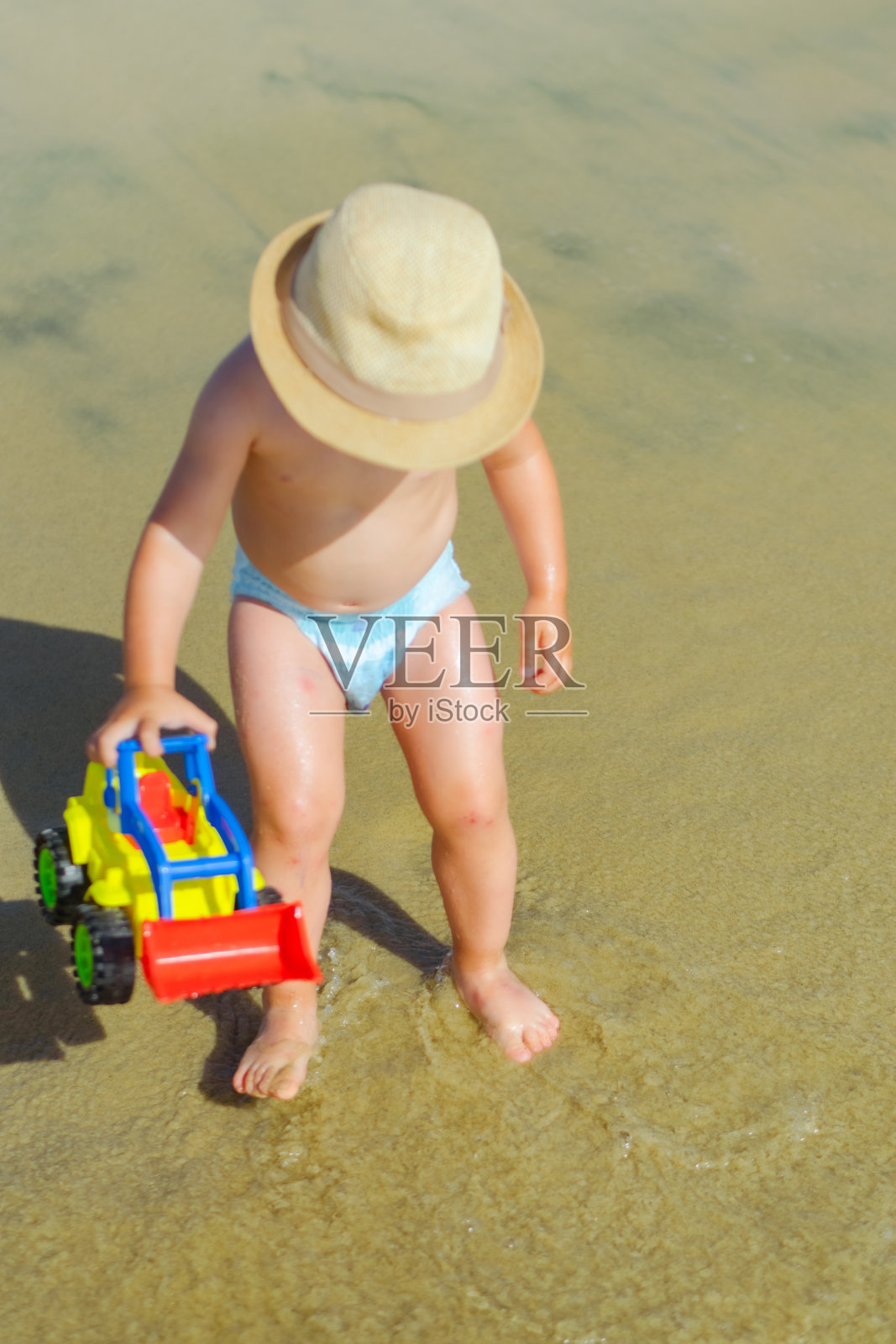 男孩在沙滩上玩耍的照片照片摄影图片