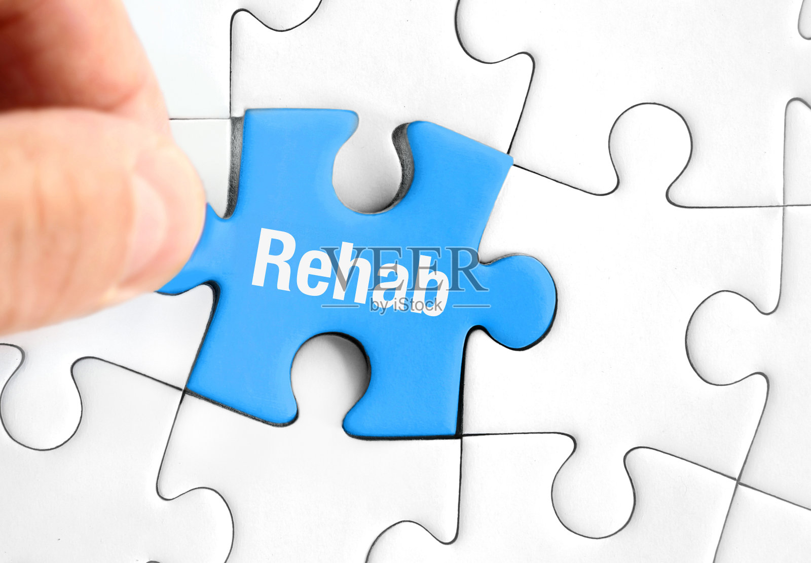 蓝色拼图与“康复”的手-康复和治疗照片摄影图片