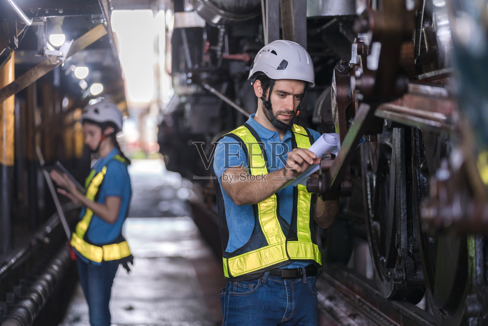 检查铁路施工过程和车站的检查工作。铁路工程师在火车站检查机器。列车工程师概念照片摄影图片