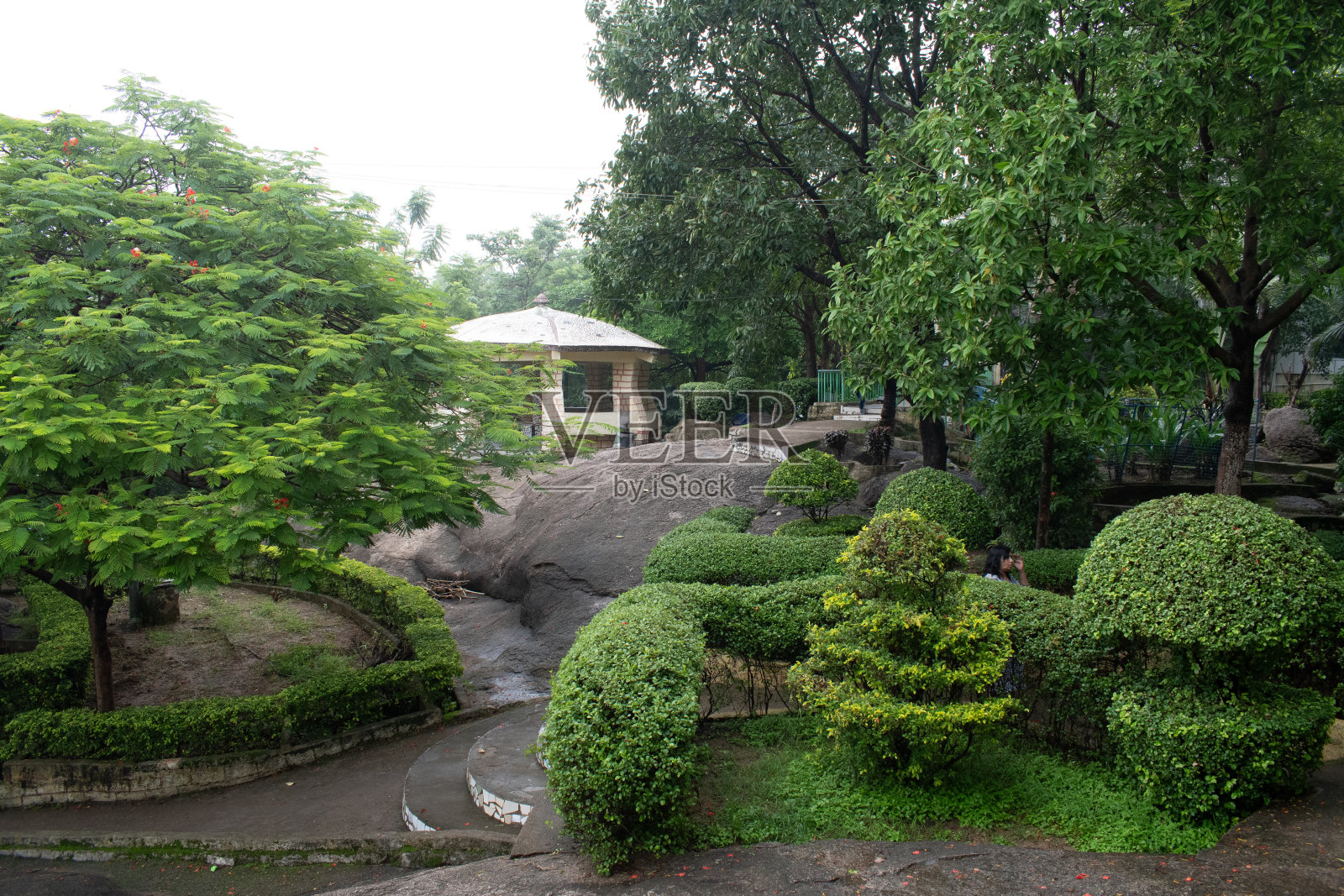 有遮蔽的地方,周围有丰富的绿色植物和装饰的花园照片摄影图片