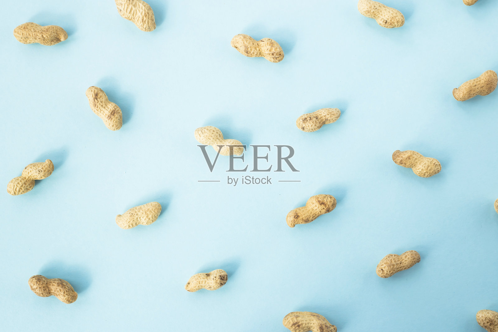 蓝色背景下的花生特写照片摄影图片