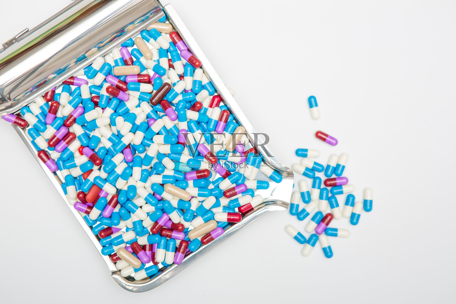 胶囊从托盘溢出白色背景照片摄影图片