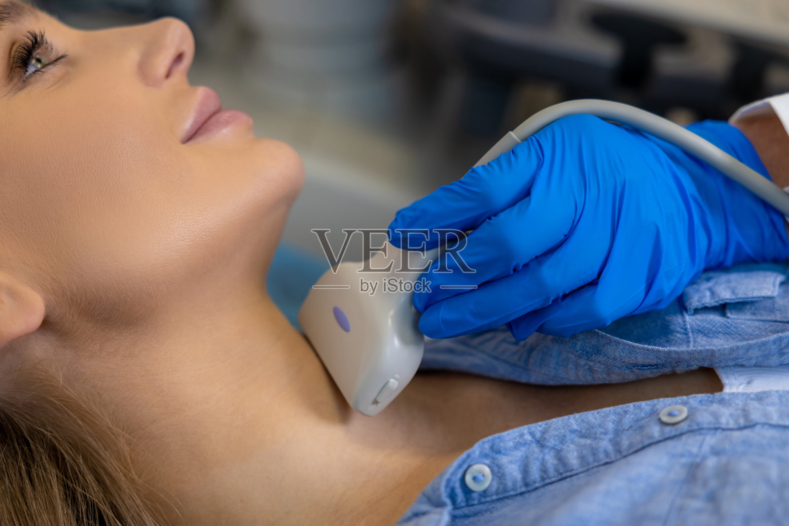 一名年轻女子正在接受甲状腺超声检查照片摄影图片