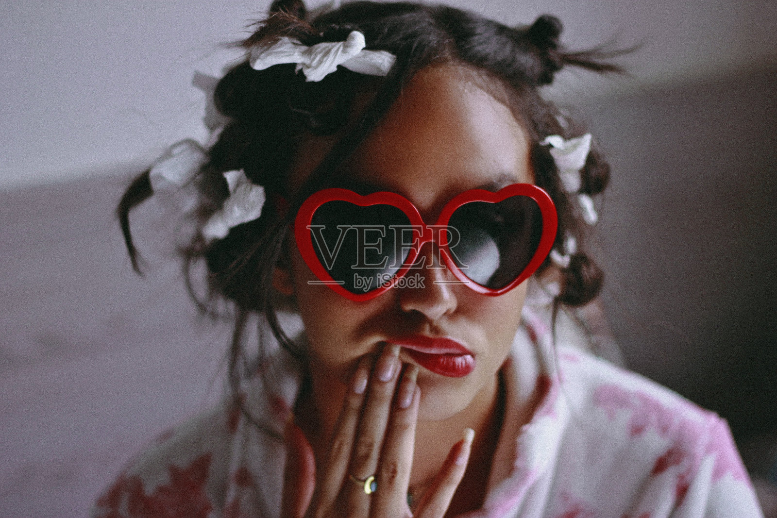 妇女的特写肖像扎头发戴太阳镜在家里照片摄影图片