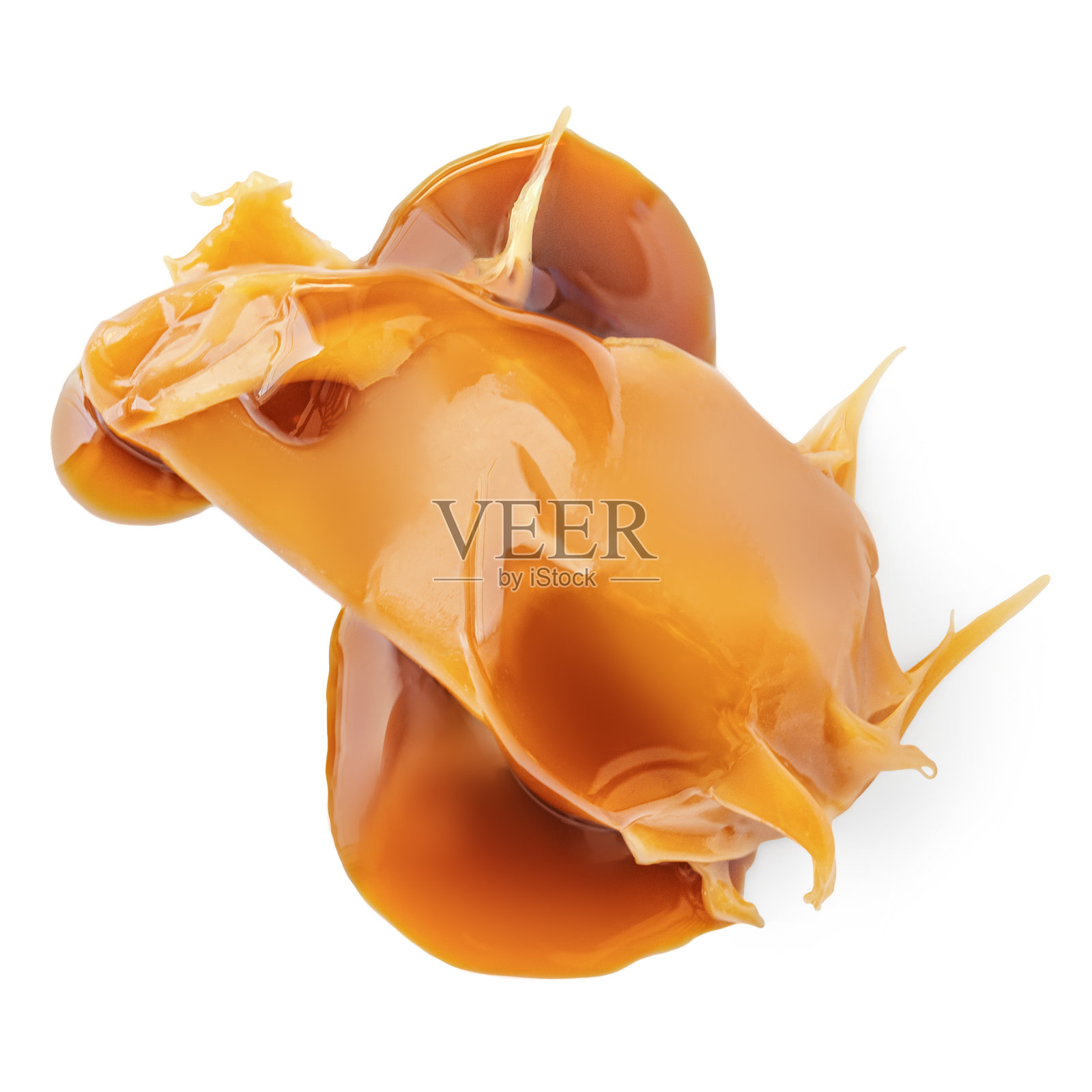 焦糖分离。焦糖和牛奶焦糖酱滴流下白色的背景。俯视图照片摄影图片