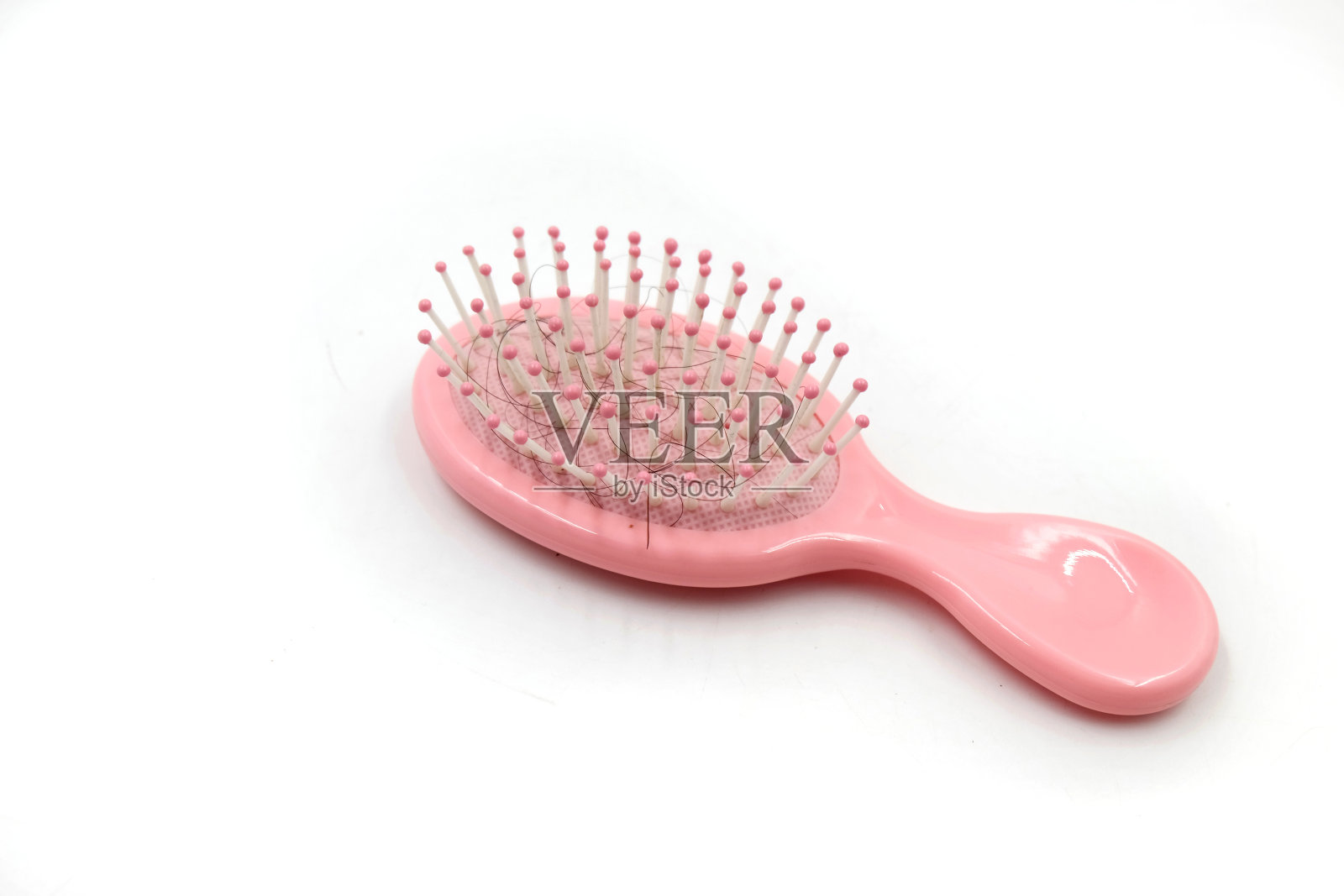 粉红色的梳子和松散的头发照片摄影图片