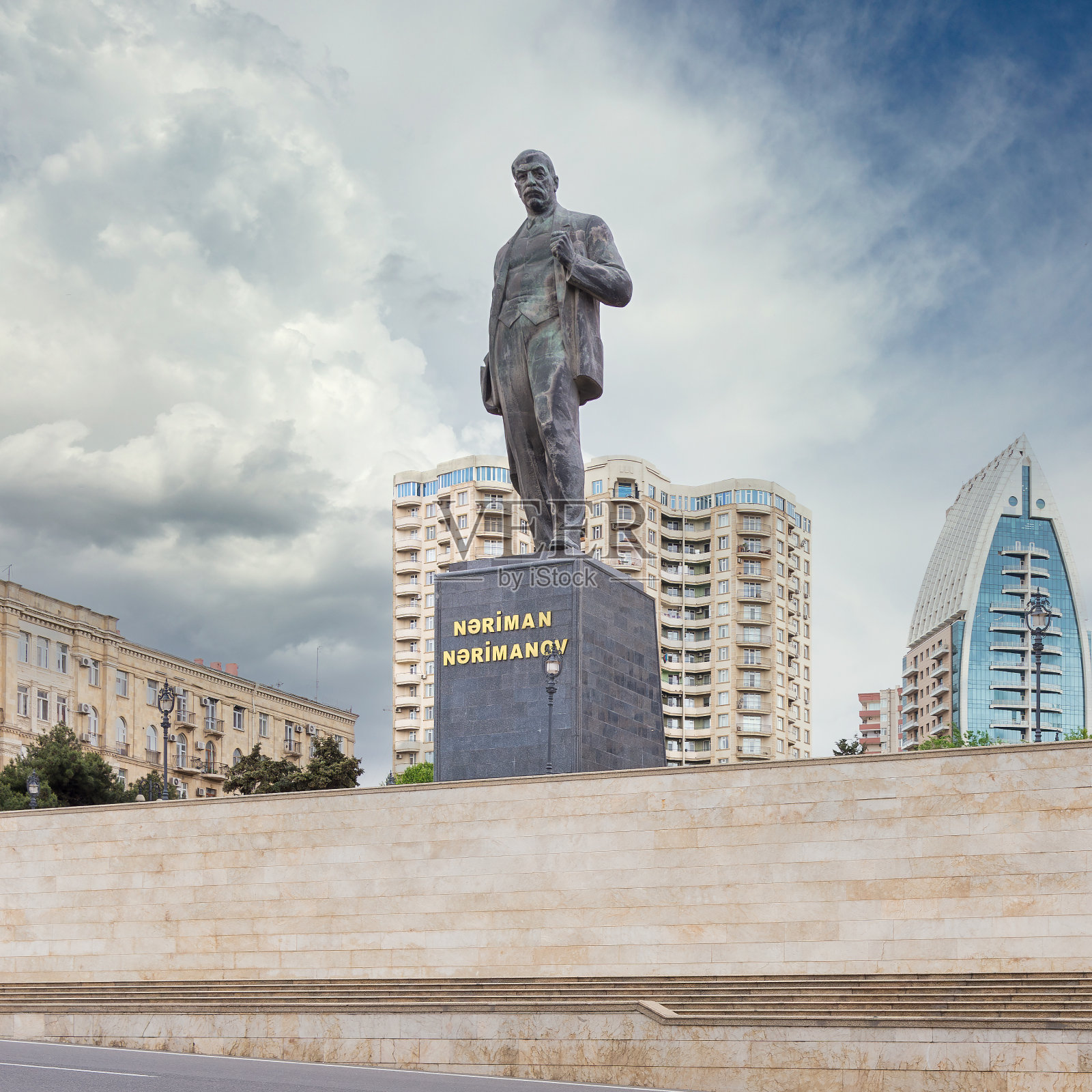 纳里曼·纳里马诺夫的雕像矗立在阿塞拜疆的巴库，周围环绕着现代建筑，天空绚丽夺目照片摄影图片