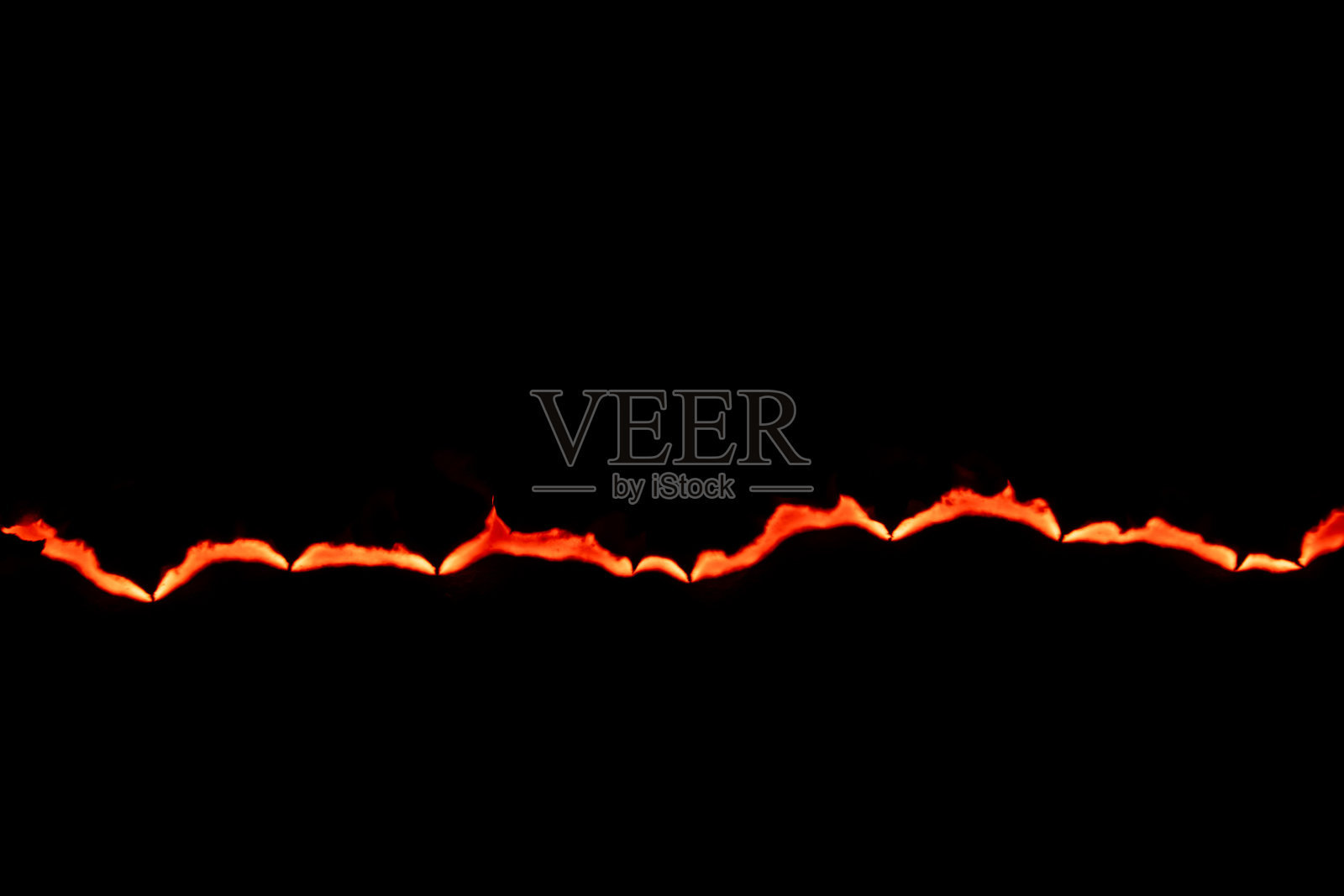 燃烧的纸，在黑色背景上发光的纸边照片摄影图片