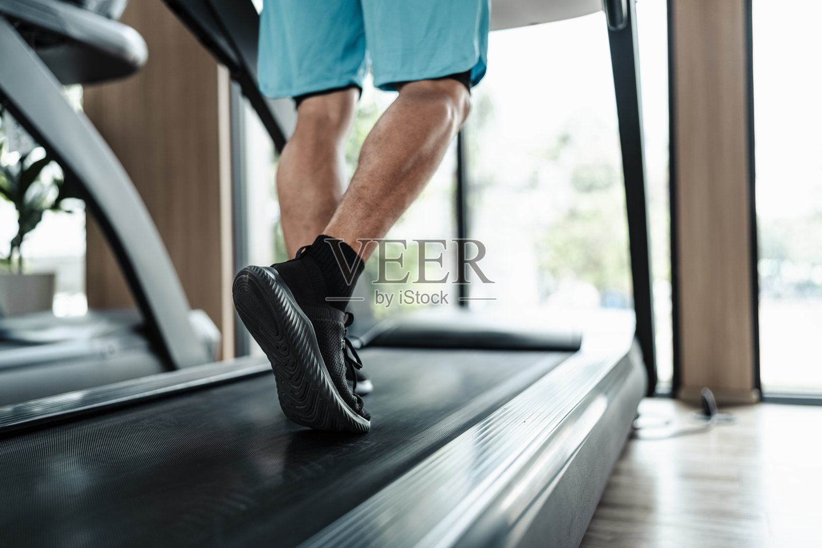 一个人在跑步机上跑步，锻炼健身。健身，健身房，锻炼和生活方式的概念。照片摄影图片