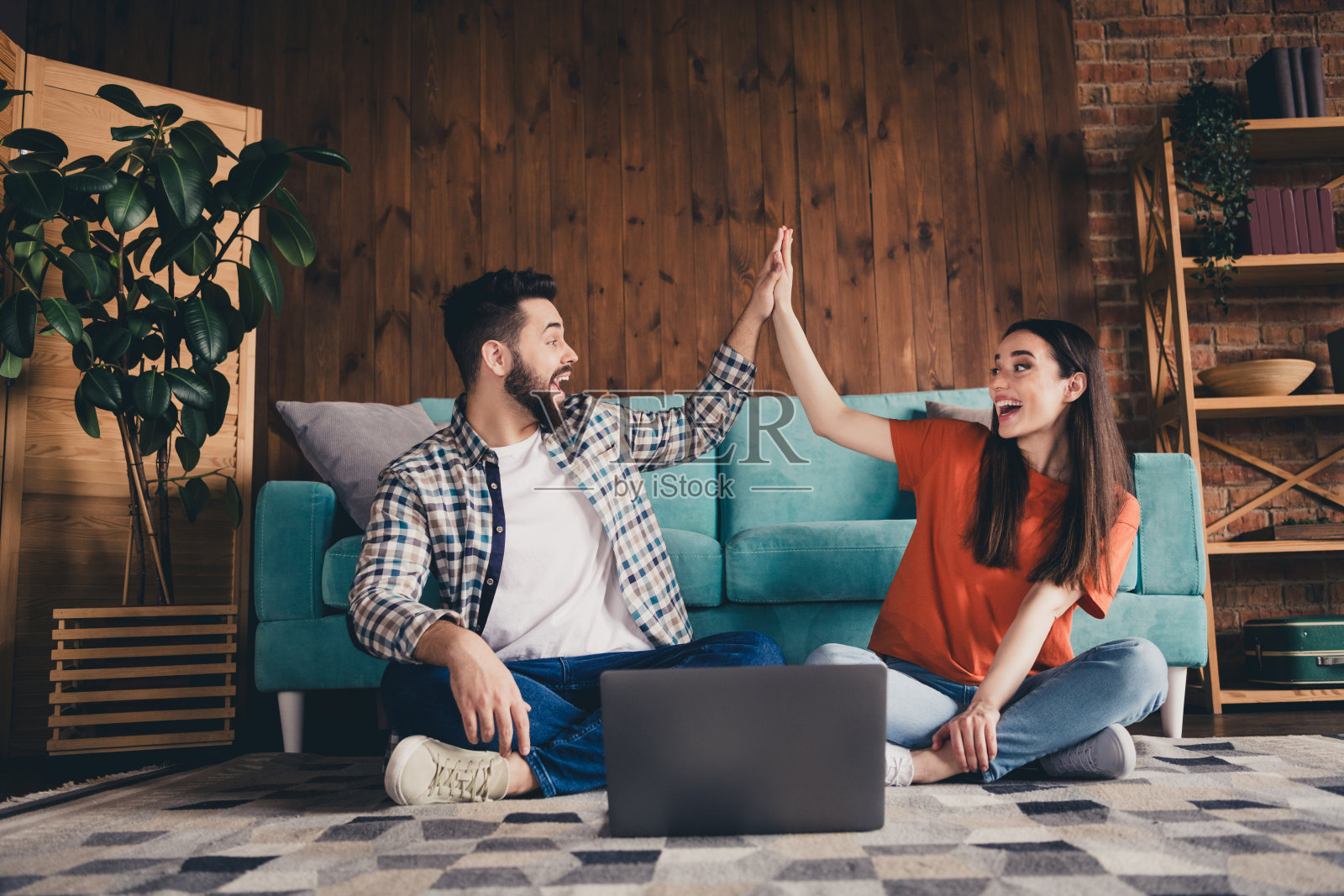 幸福的年轻夫妇的全尺寸照片坐在地板上网本击掌移动新的地方享受住在一起公寓房间灯房子公寓室内照片摄影图片