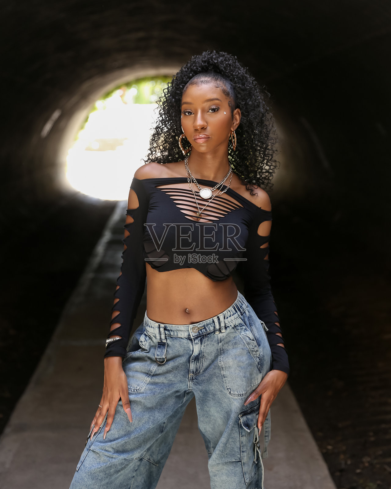 穿着时髦的少女在戏剧性的灯光下照片摄影图片