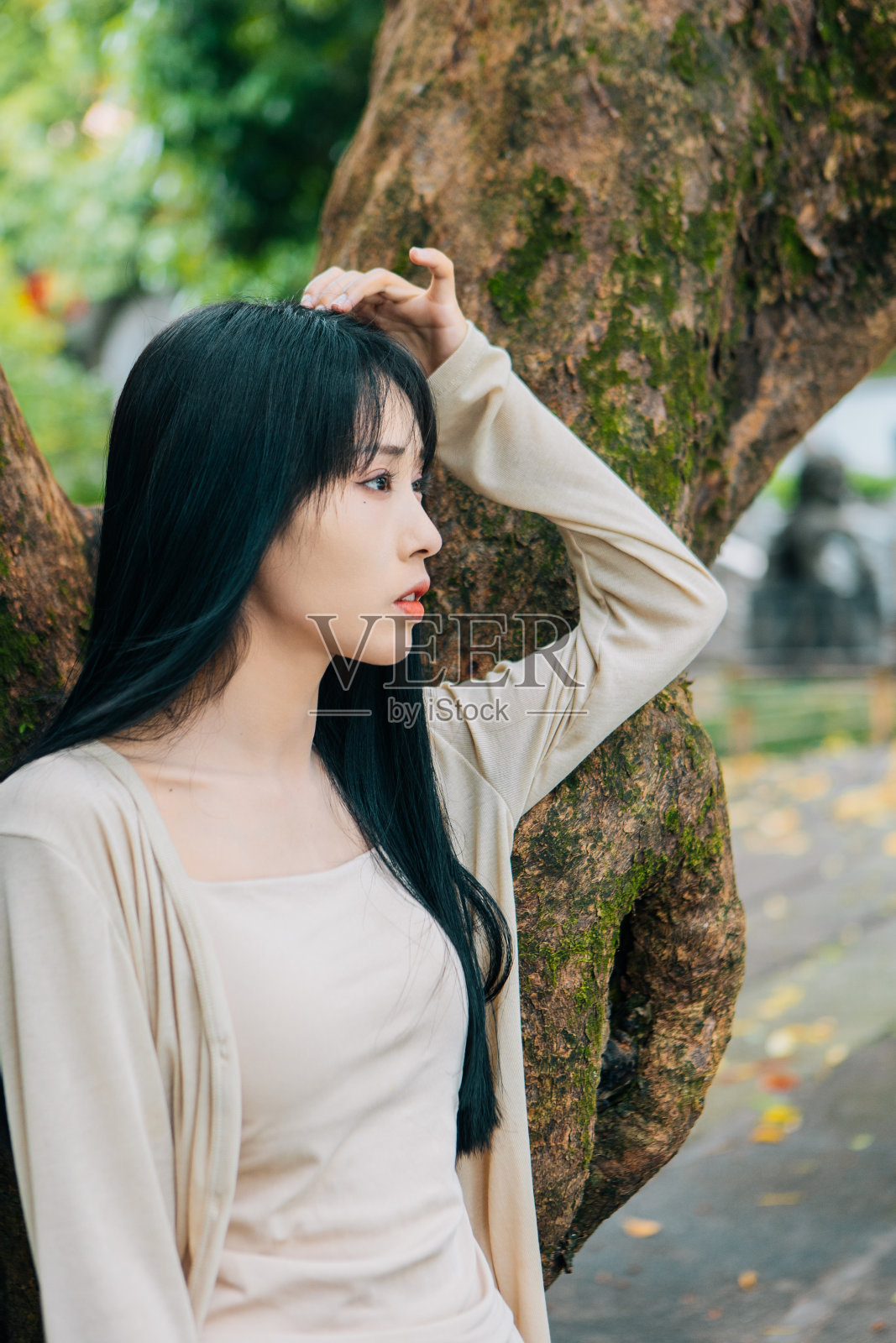 秋天，一个美丽的女人在一个中国古建筑的公园里旅行照片摄影图片