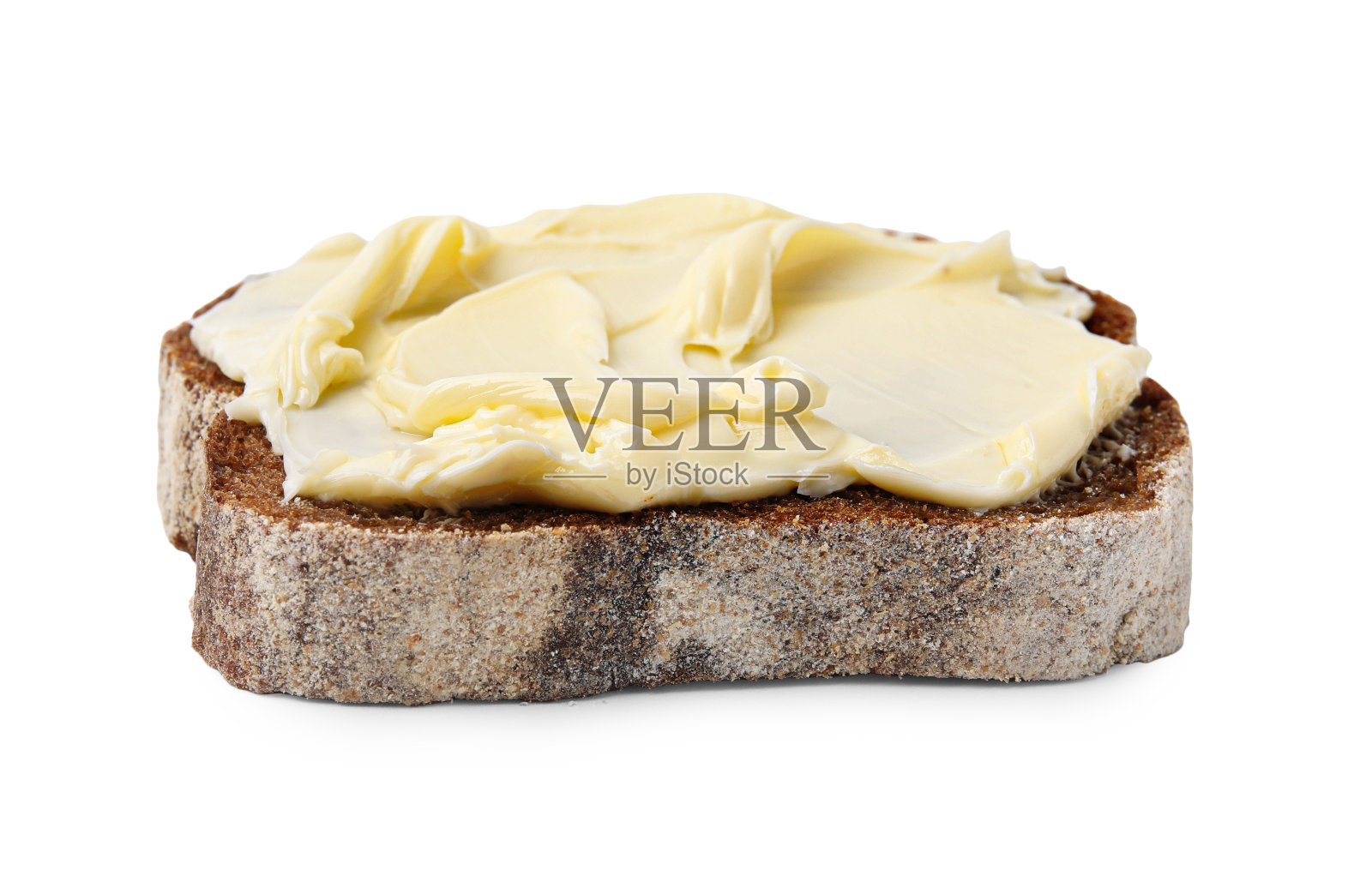 一片美味的面包，涂上黄油，孤立在白面包上照片摄影图片