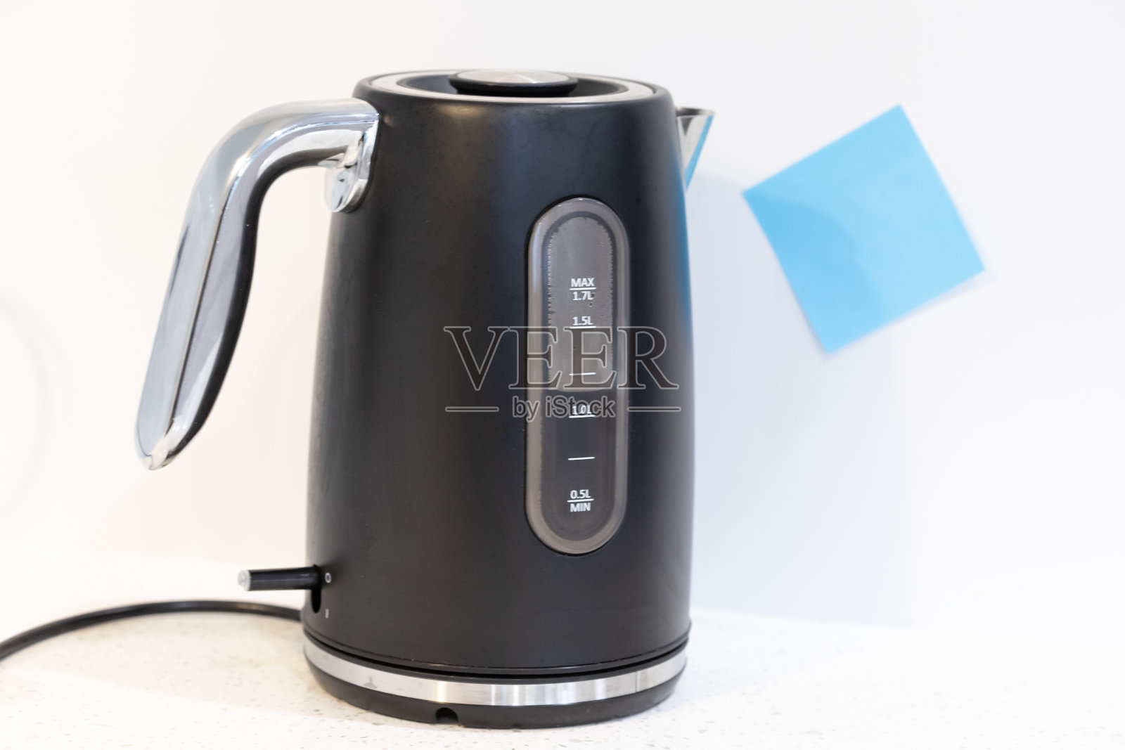 厨房里的水壶，上面贴着蓝色便签照片摄影图片