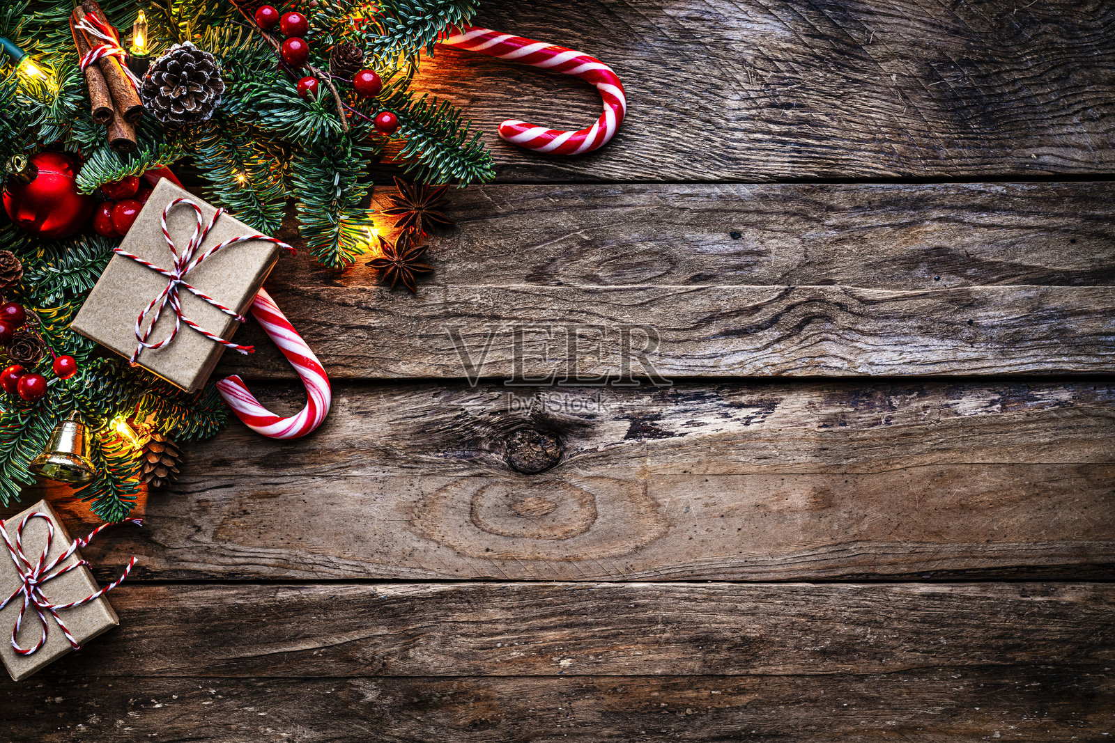 圣诞装饰上的旧木背景串灯，冷杉树，圣诞礼物和糖果手杖复制空间照片摄影图片