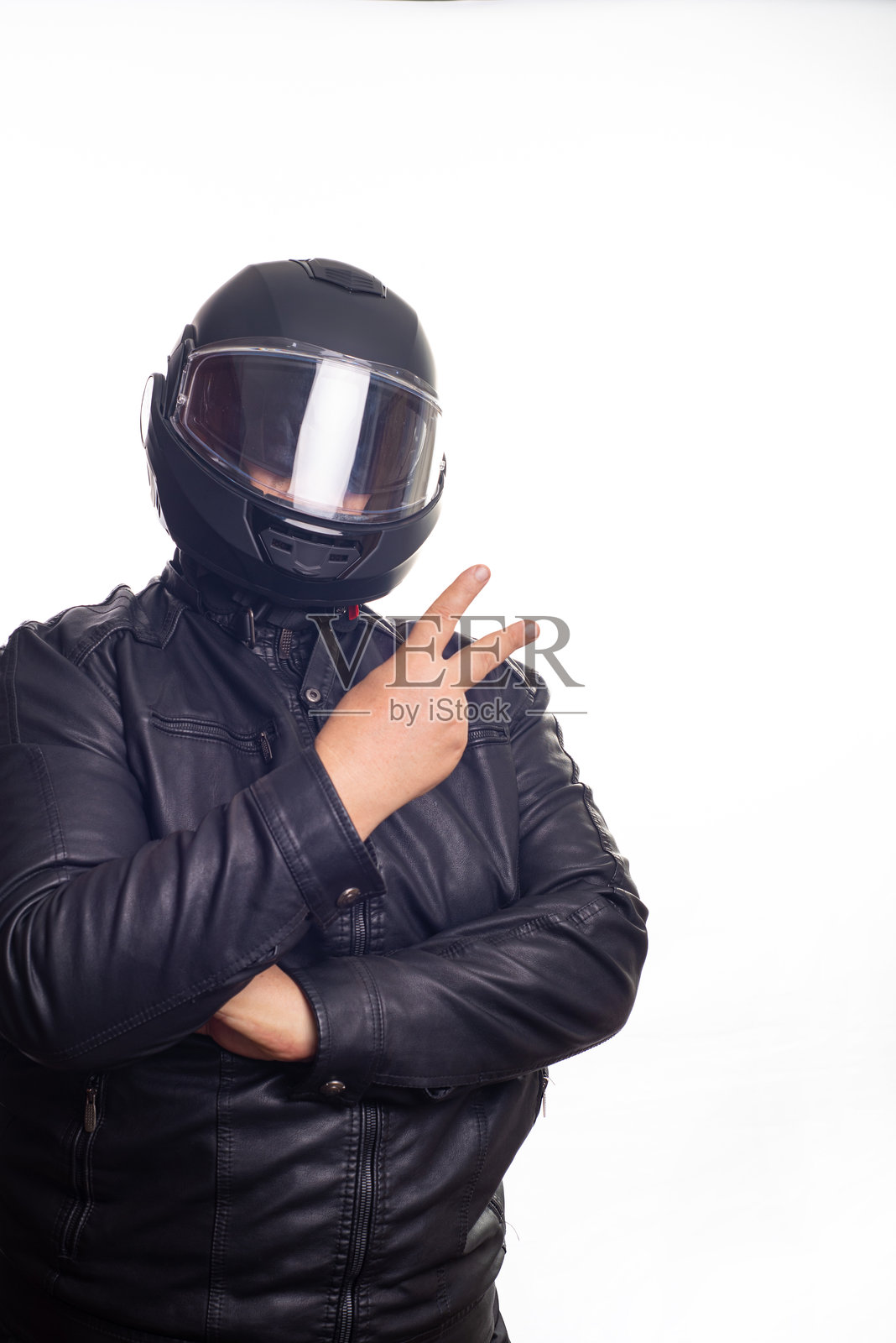 摩托车手，一个穿着黑色摩托车服，戴着头盔的成年男子站在白色背景前，选择性聚焦。照片摄影图片