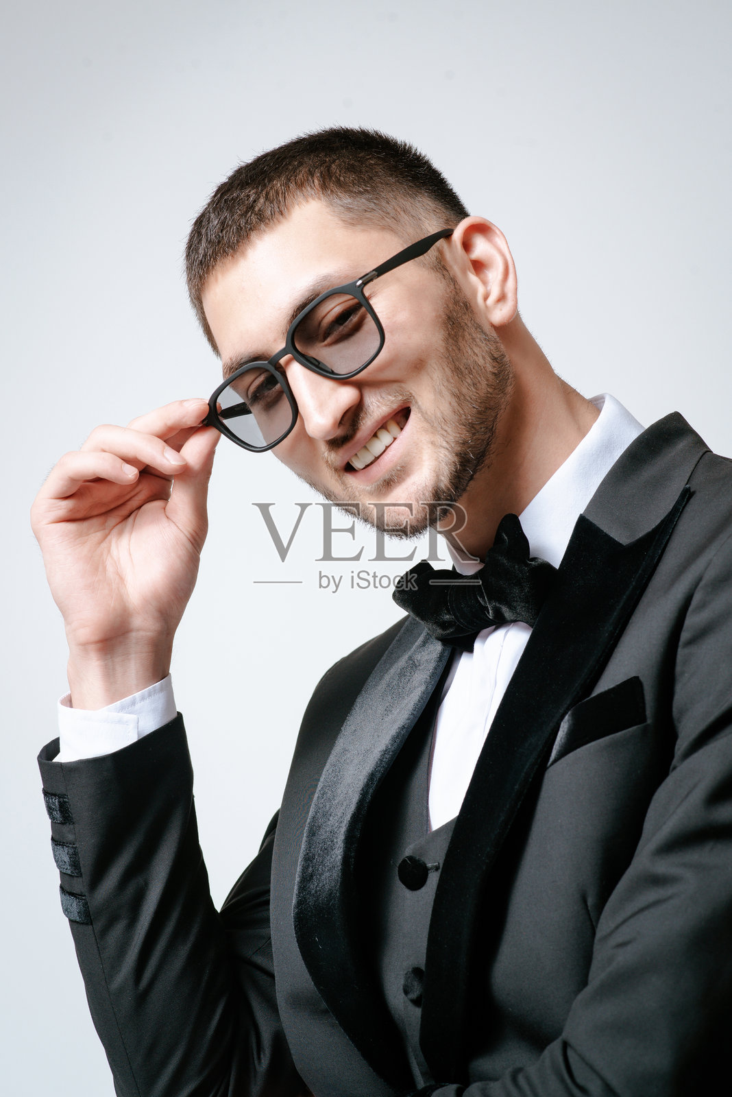 帅哥，时尚模特，黑色服装，无尾礼服，领结和太阳镜照片摄影图片