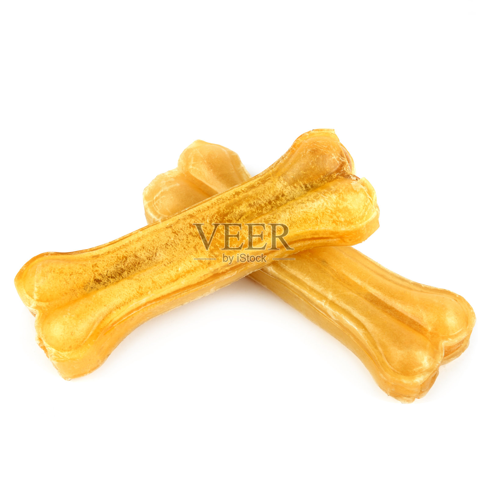 咀嚼骨头的狗孤立在白色，俯视图。宠物玩具照片摄影图片