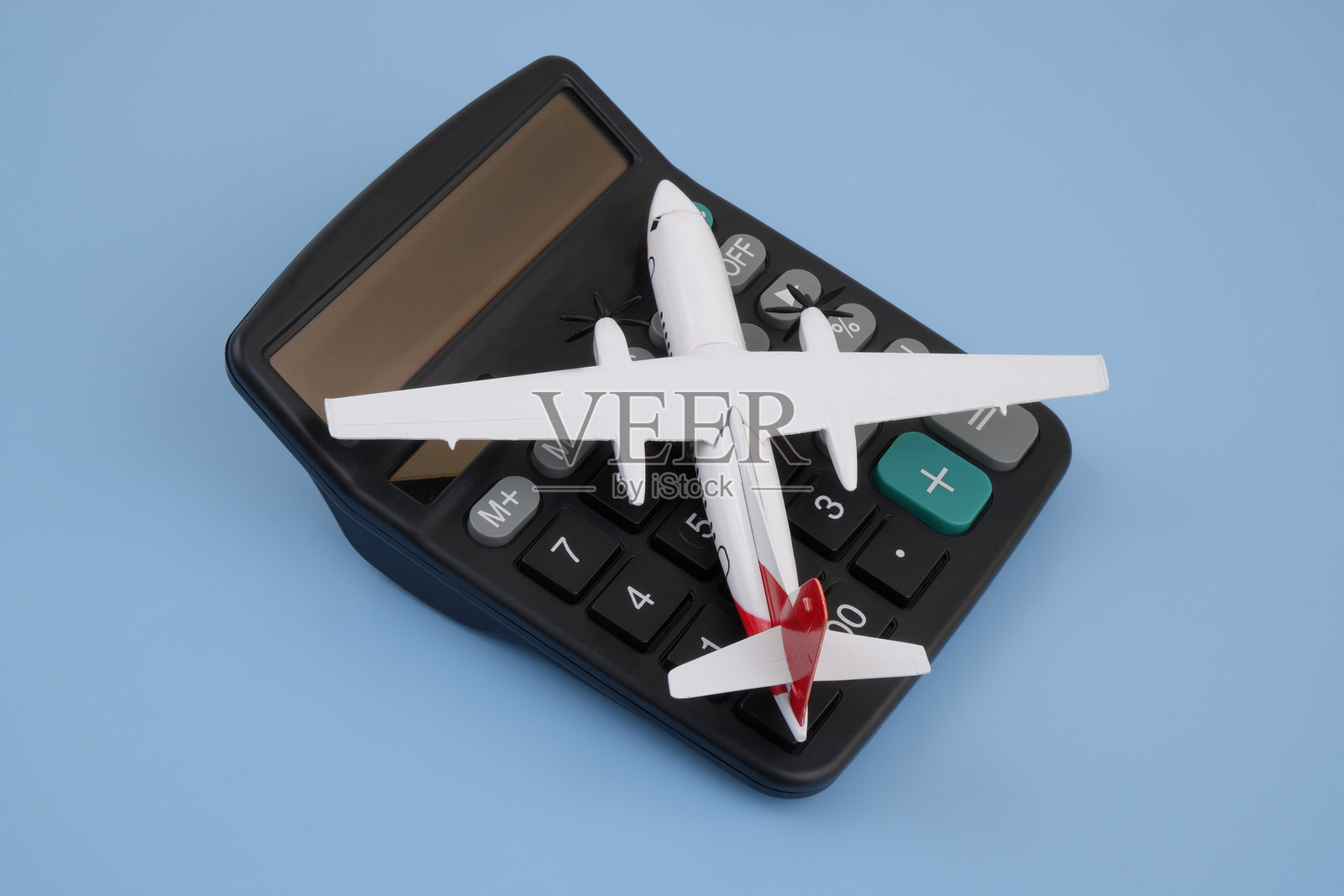 飞机上的黑色计算器上的蓝色背景。照片摄影图片