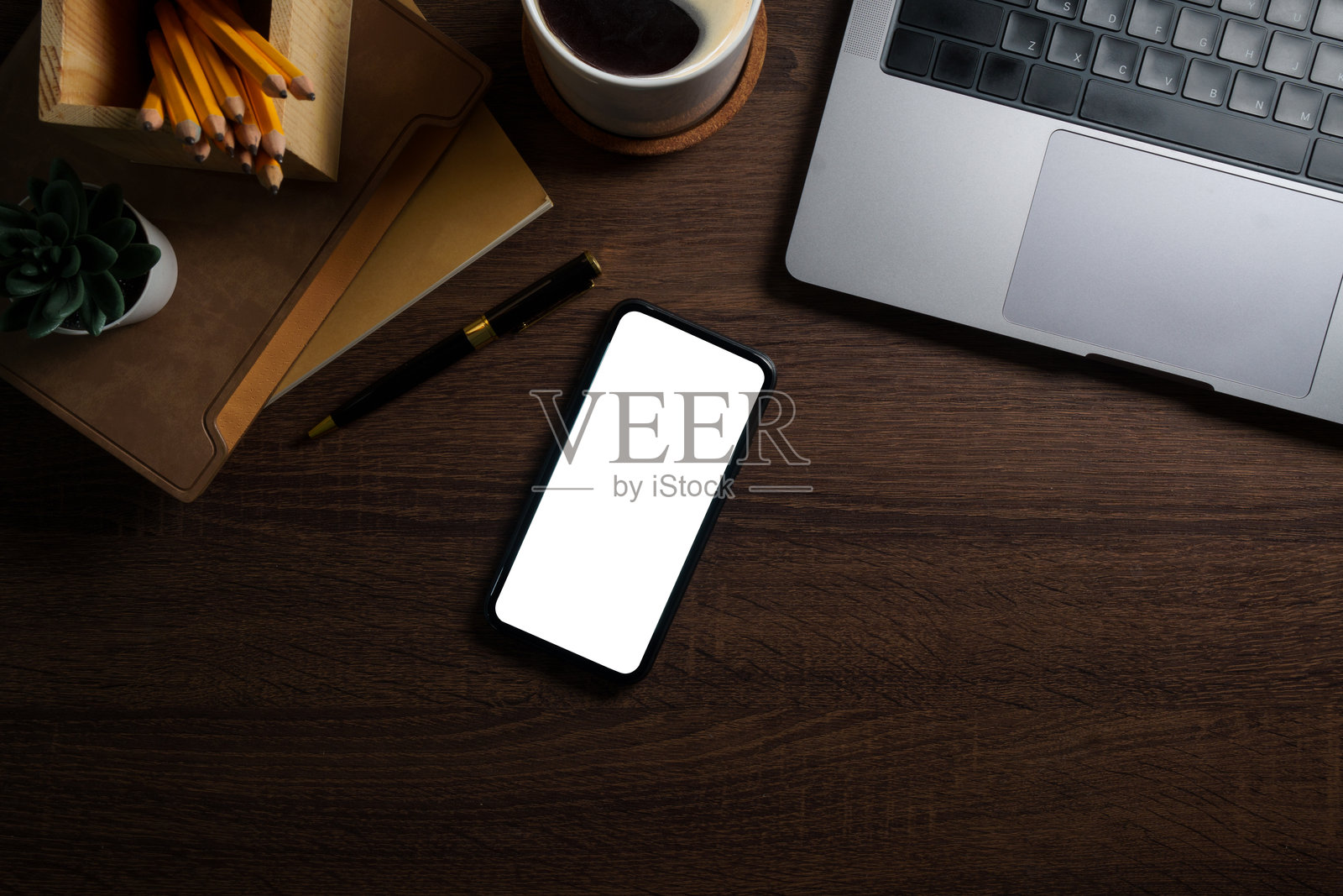 智能手机、笔记本、咖啡杯和键盘放在质朴的木桌上。带有文本空间的俯视图。照片摄影图片